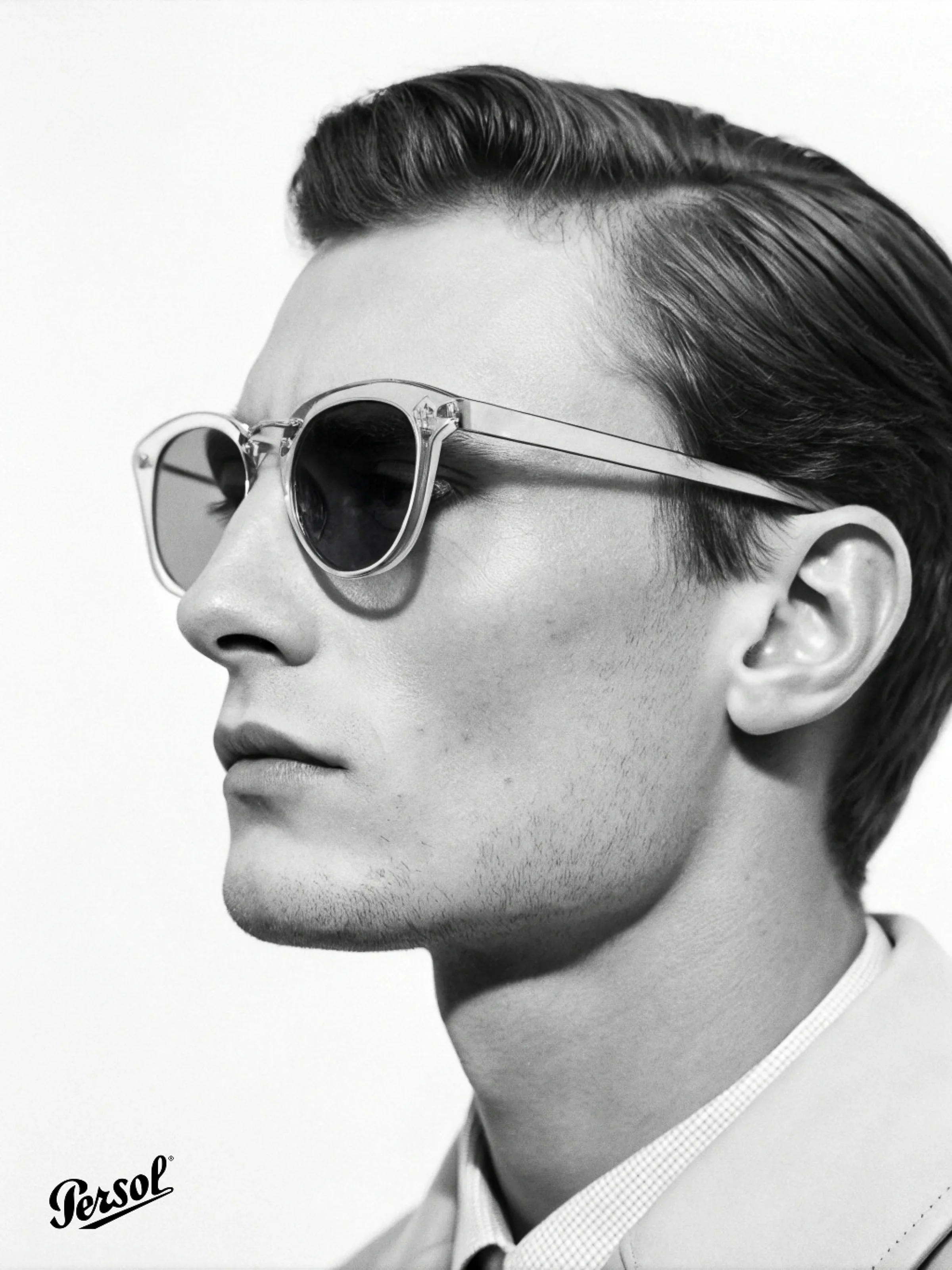 AI image of a man in profile wearing clear-frame sunglasses, black and white. Persol AI Concept.