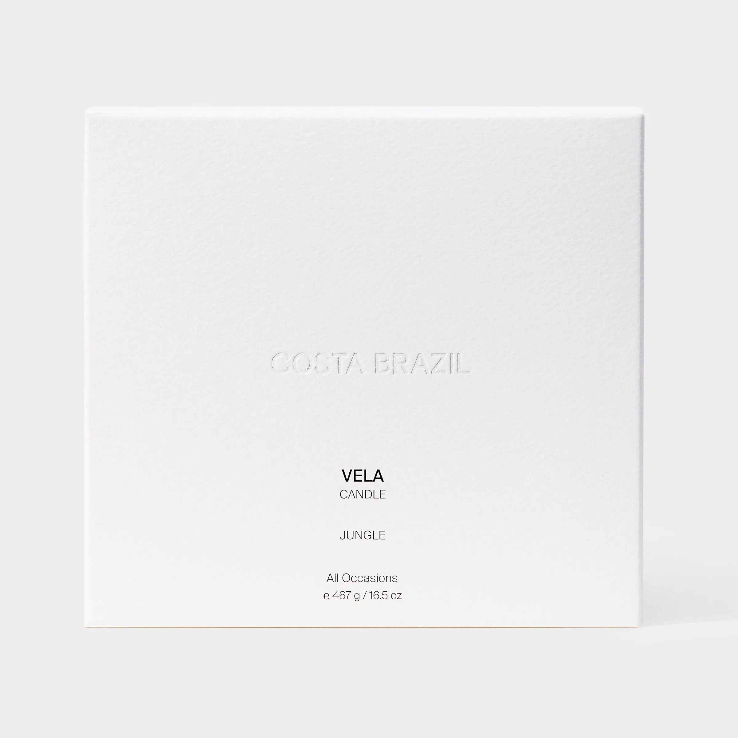 White textured candle box with embossed logo and Vela Jungle candle label on a light grey background, for Costa Brazil.
