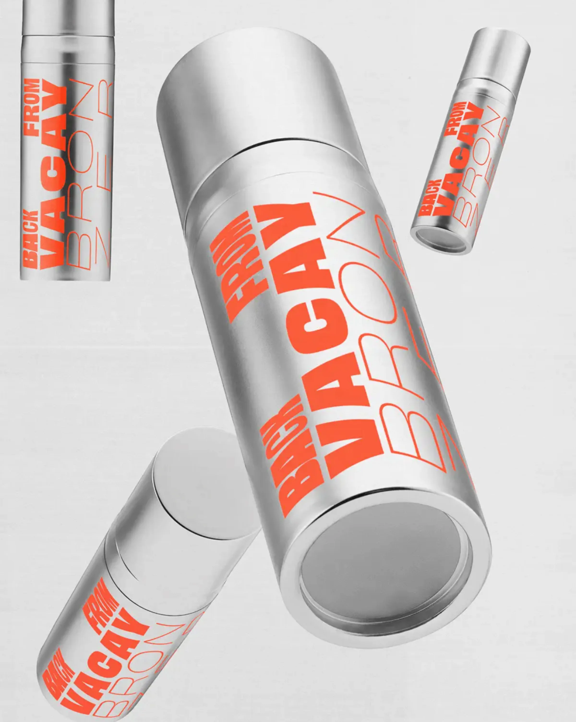 Silver Back From Vacay bronzer tubes with orange lettering floating against a pale grey background, for Good Weird.