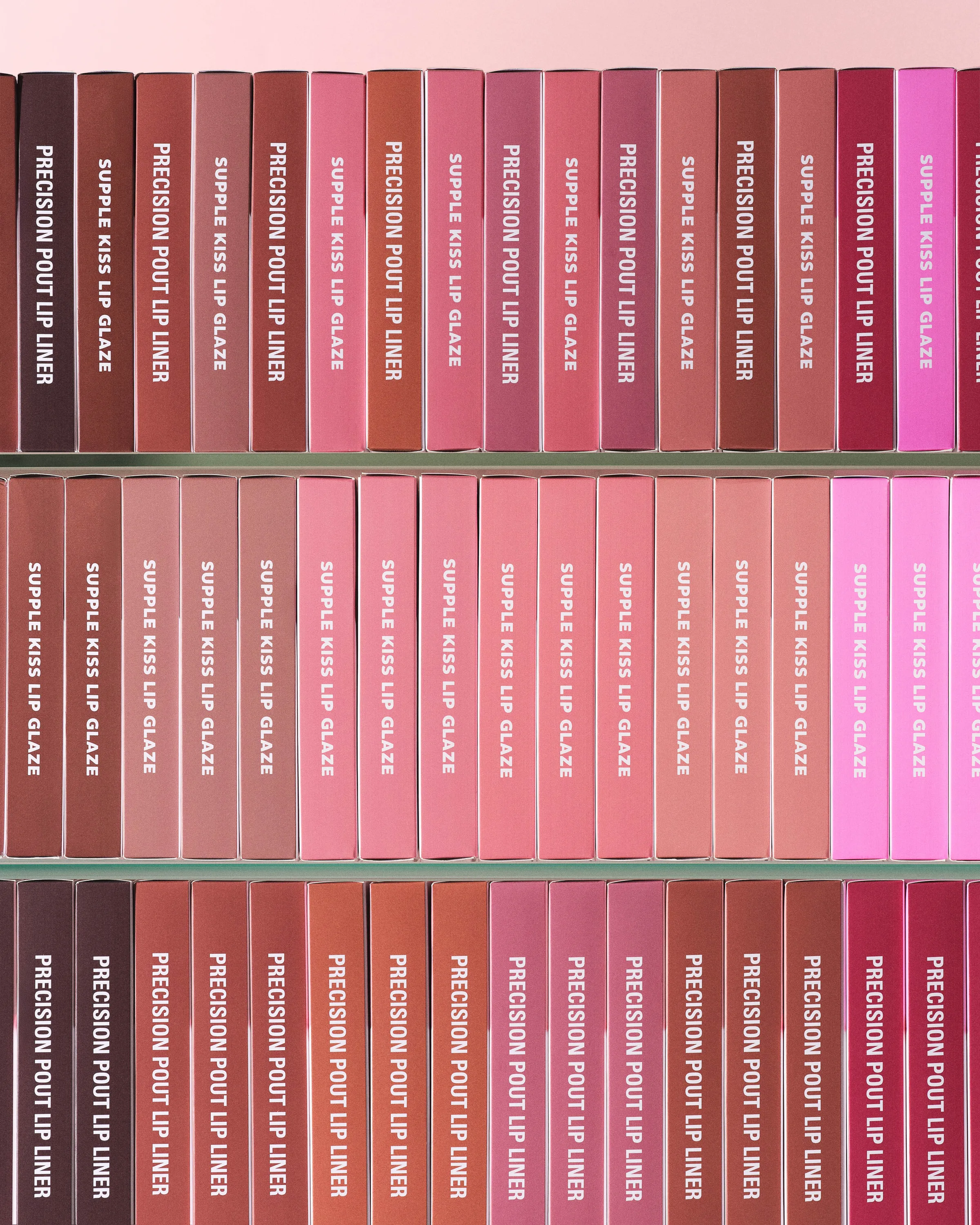 Rows of pink and brown lip liner and lip glaze boxes standing on glass shelves, for Kylie Cosmetics.