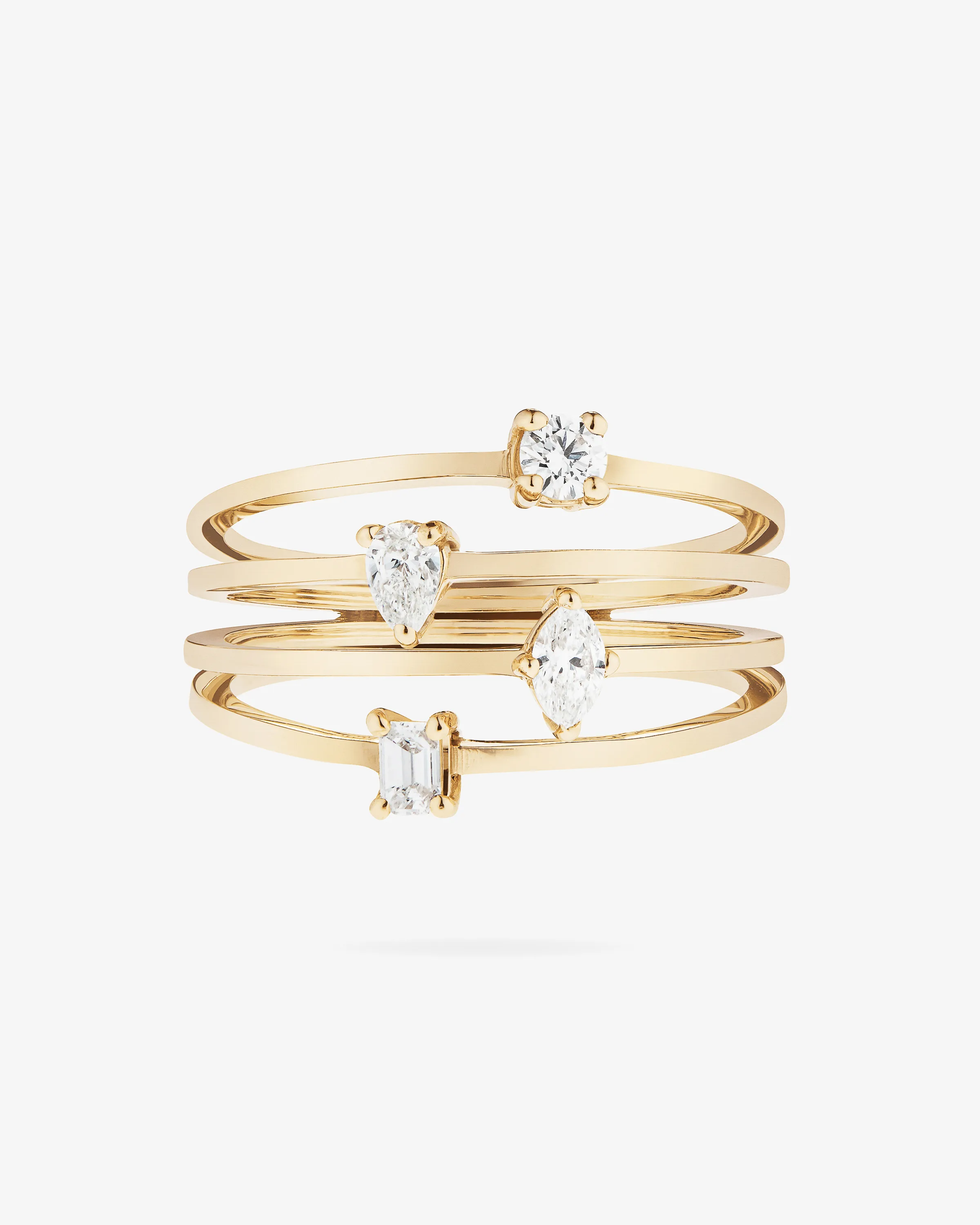 Gold four-band stacked ring set with round, pear, marquise and emerald-cut diamonds on white, for Lana Jewelry.