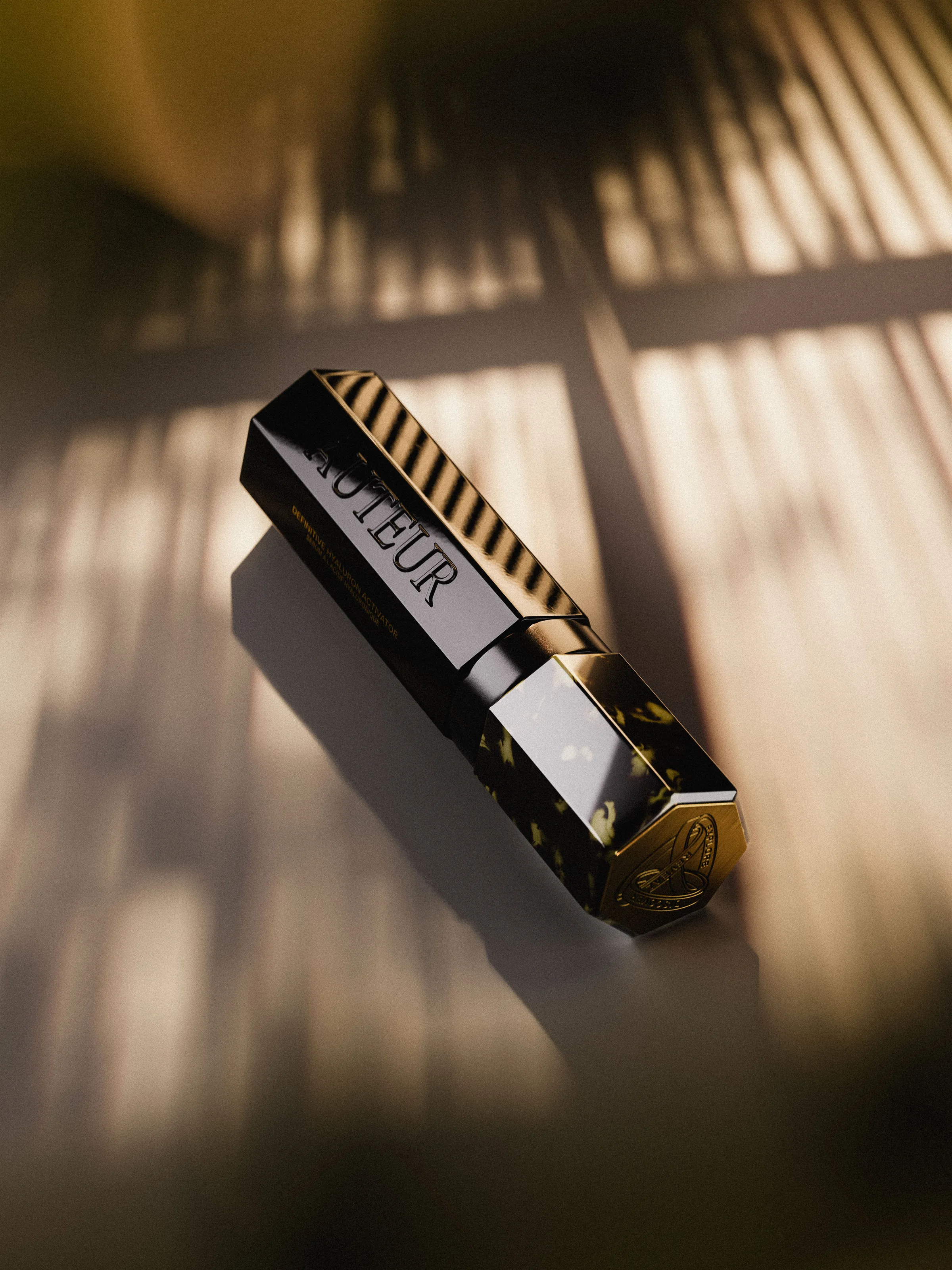 CGI render of a black and tortoiseshell lipstick tube lying in striped window shadows, for Auteur.