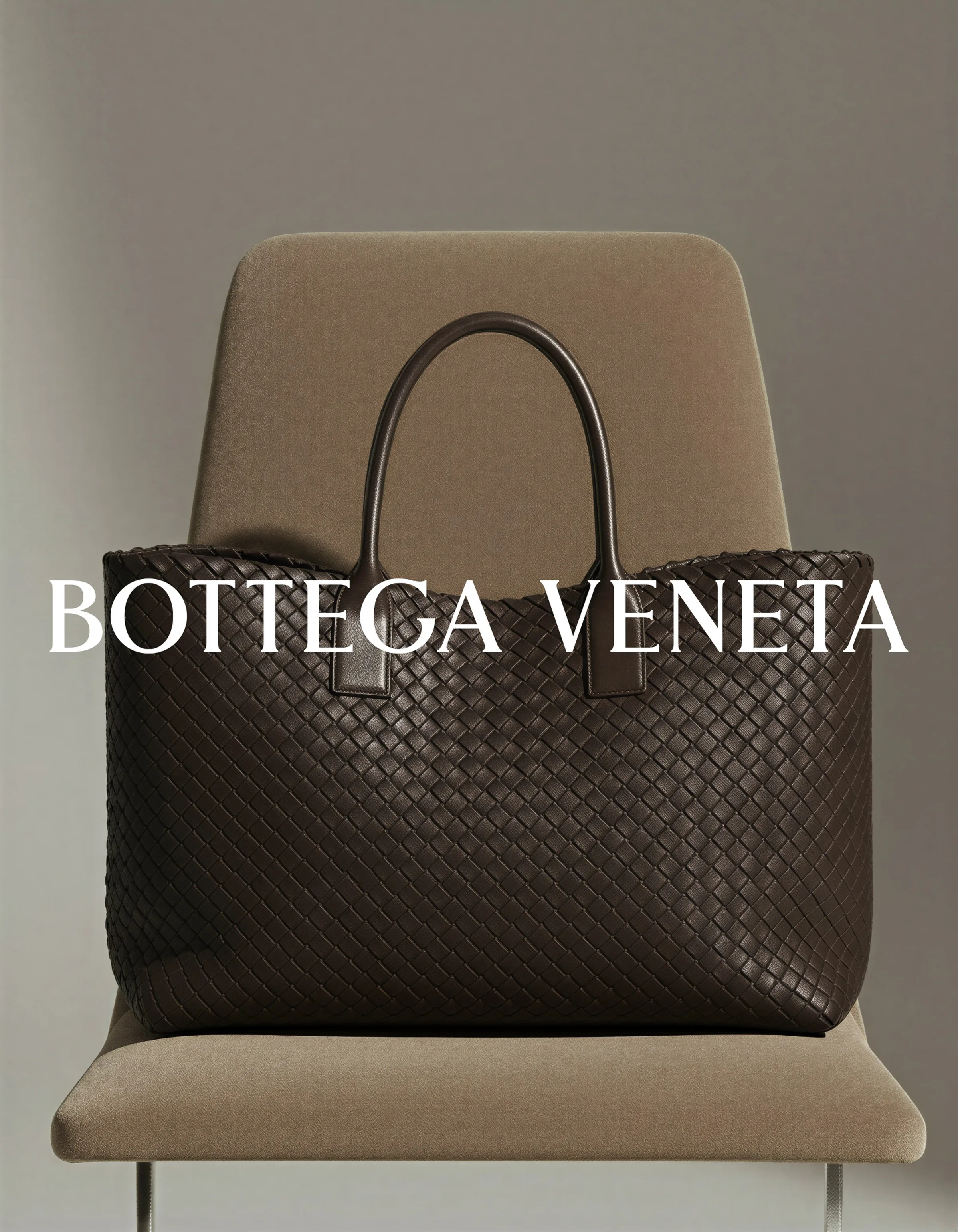 AI image of a dark brown woven leather tote resting on a taupe upholstered chair, with Bottega Veneta wordmark. Bottega Veneta AI Concept.