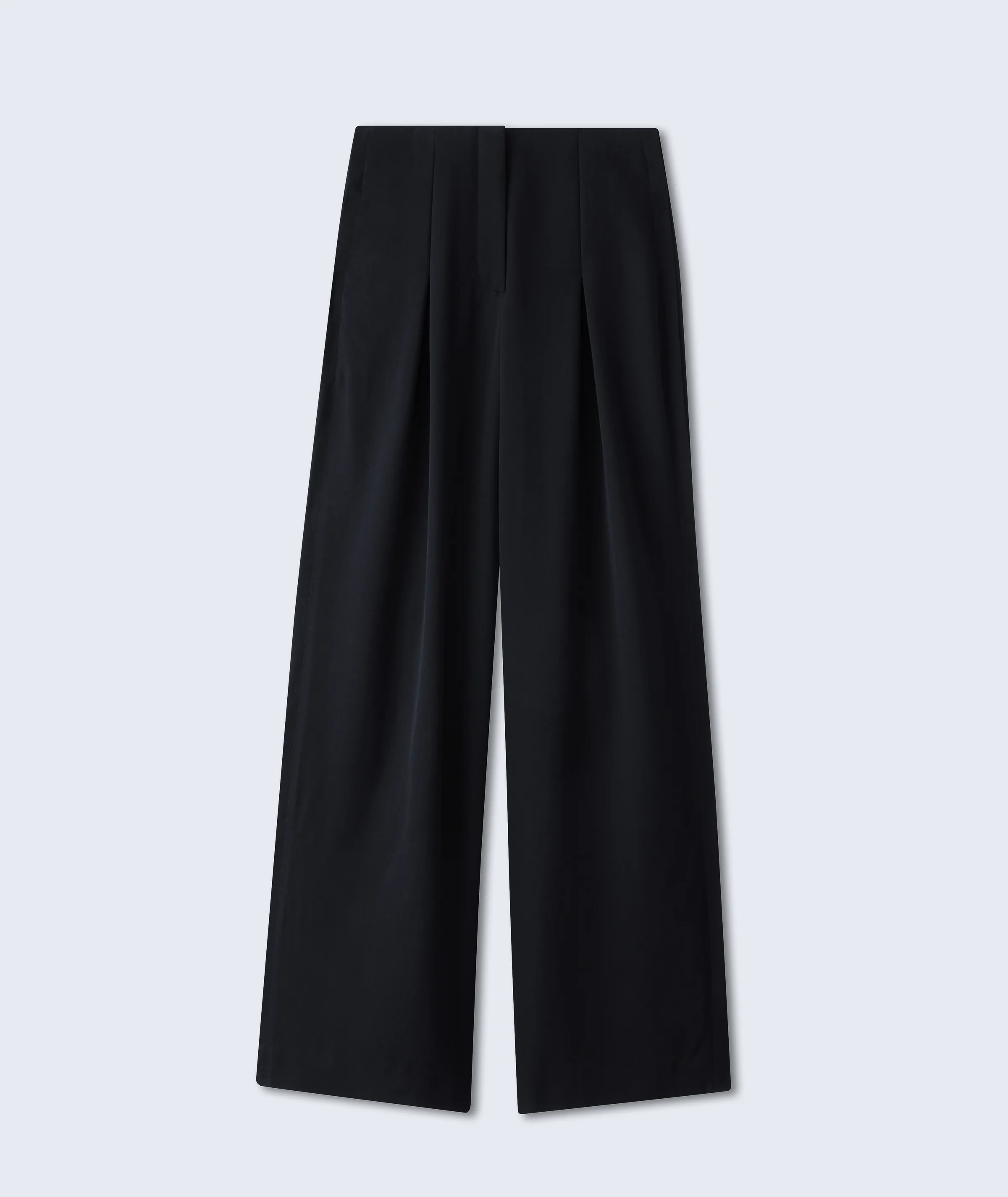 Black high-waisted pleated wide-leg trousers laid flat on a pale grey background, for Fforme.