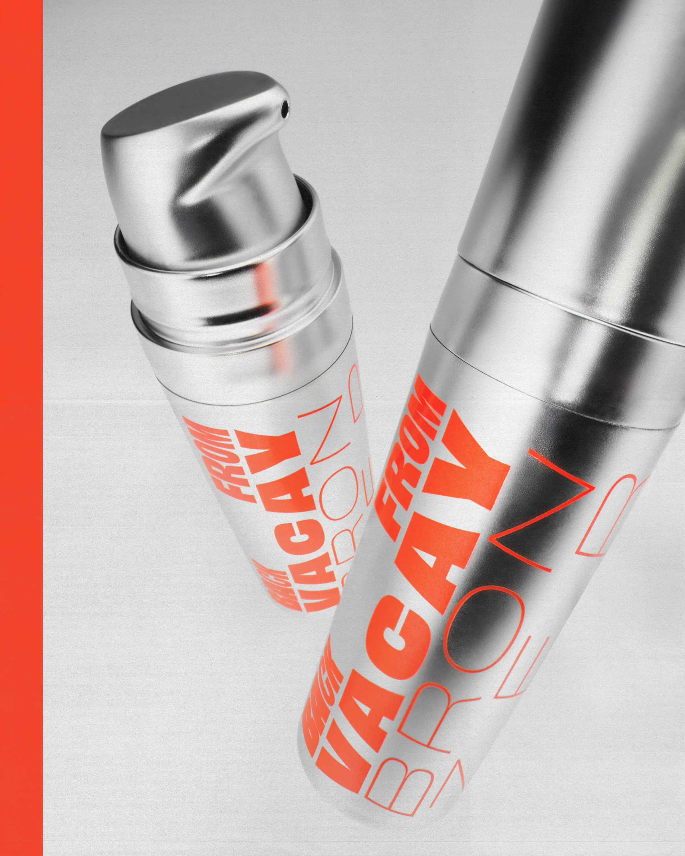 Two brushed silver pump bottles with bold orange 