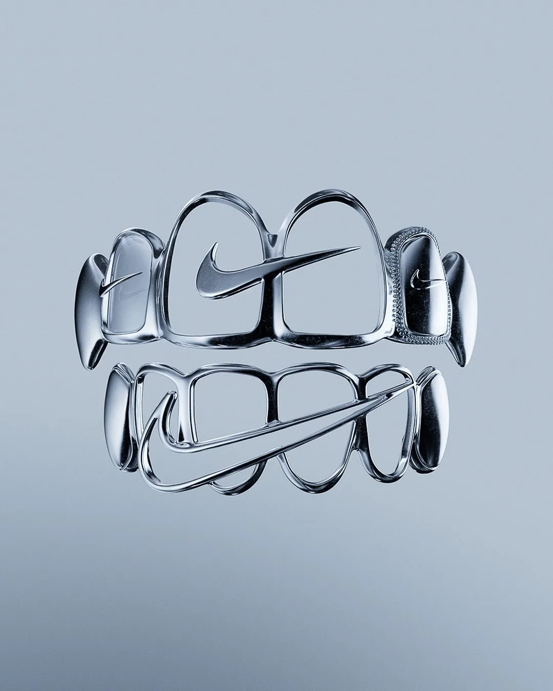 CGI render of open-frame chrome grillz with Swoosh cutouts floating on a pale blue-grey background, for Nike.