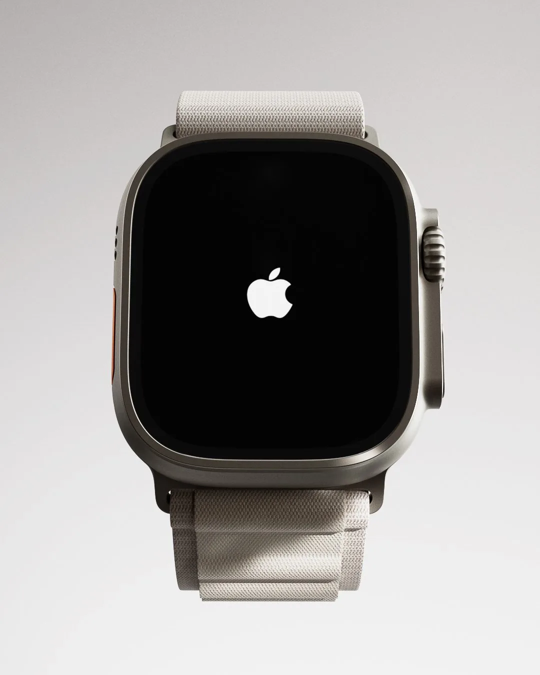 CGI render of a titanium Apple Watch Ultra with a white Alpine Loop band and Apple logo on screen, for Apple.