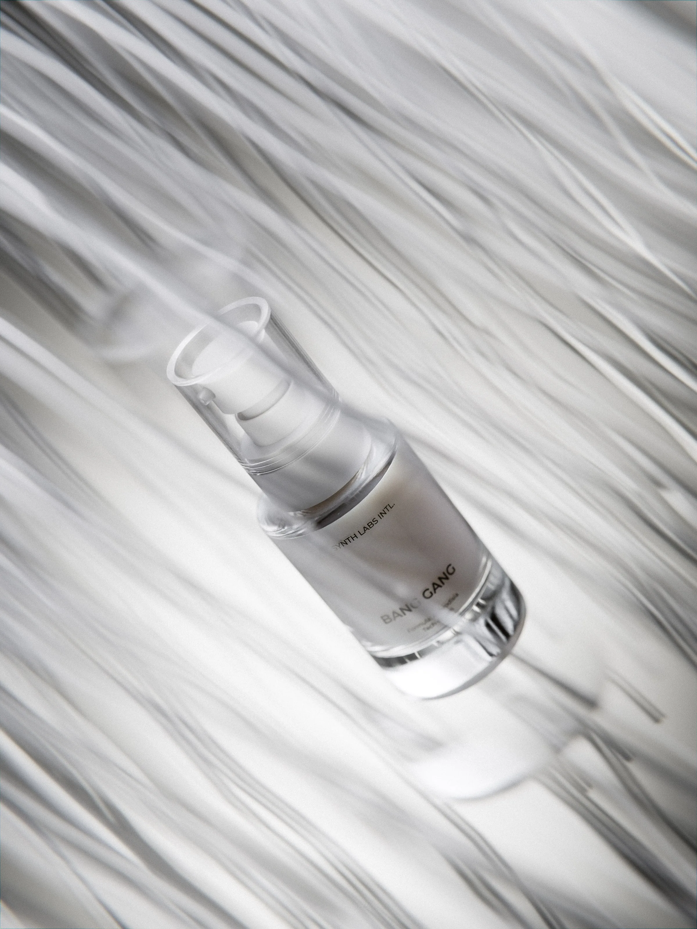 CGI render of a frosted serum pump bottle lying among swirling white strands, for Bang Gang.