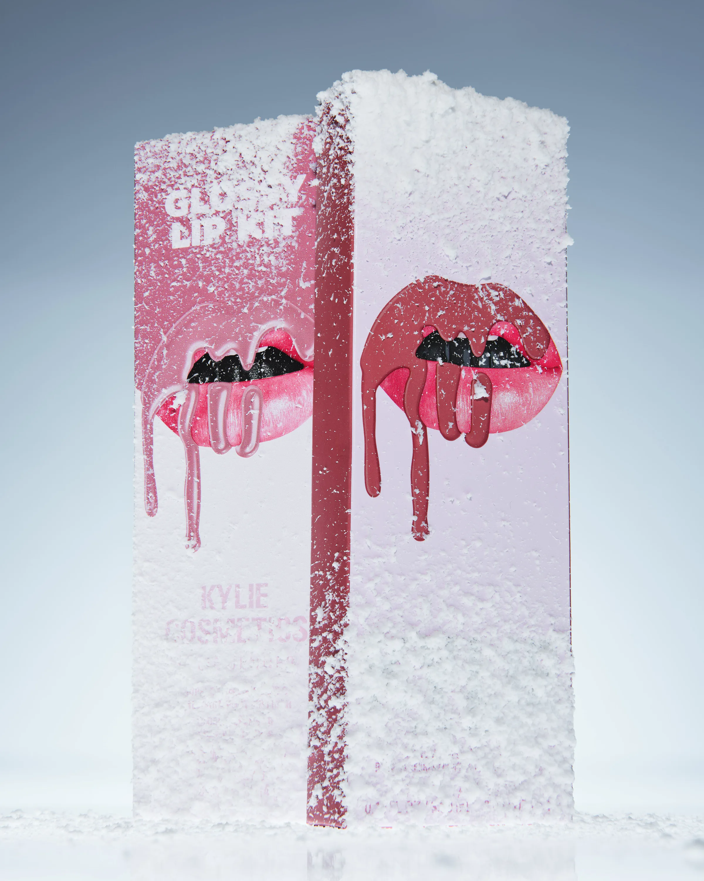 Glossy Lip Kit box with dripping lips graphic dusted in snow against a pale blue backdrop, for Kylie Cosmetics.