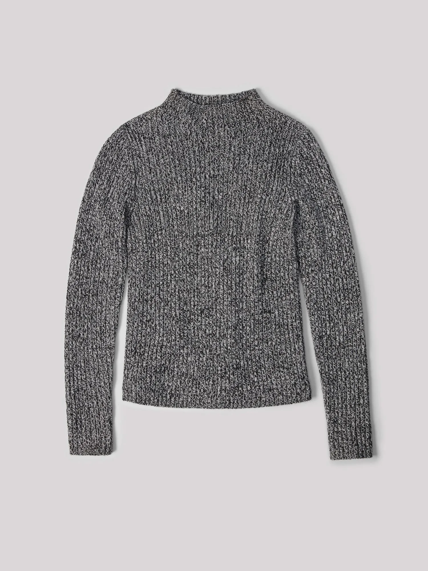 Marled black and white ribbed knit mock-neck sweater laid flat on a light grey background, for Uniqlo.