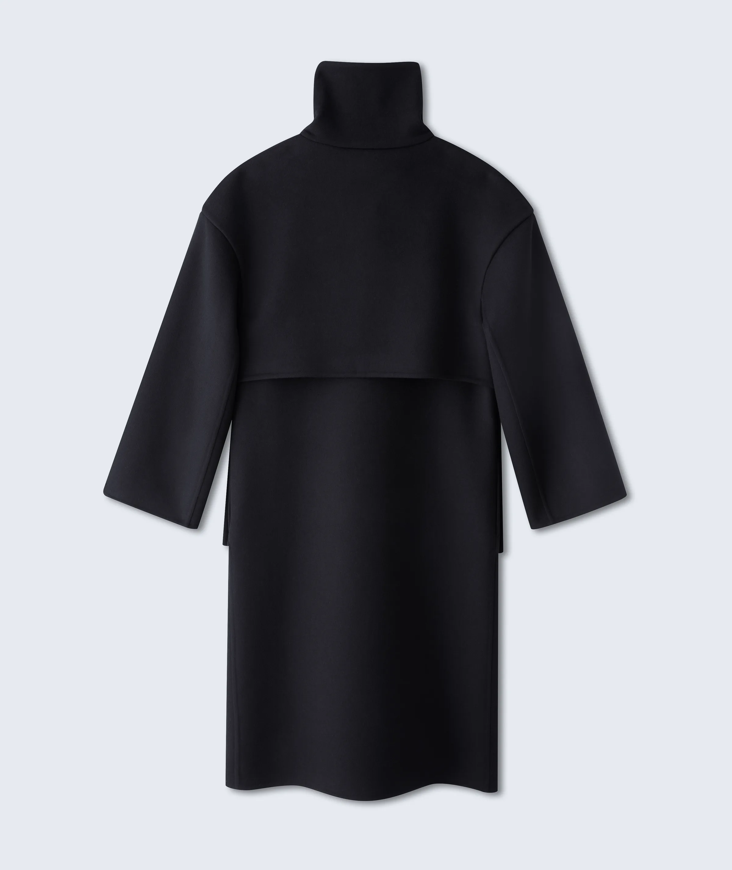 Back view of a black wool funnel-neck coat with a back yoke, laid flat on a pale grey-blue background, for Fforme.