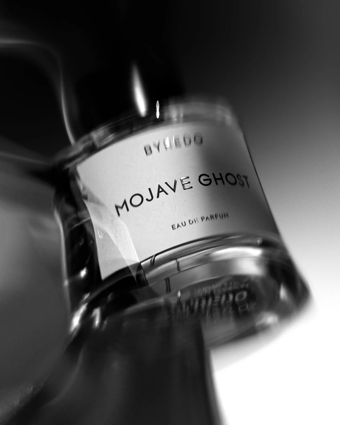 CGI render of a Mojave Ghost eau de parfum bottle tilted in black and white with motion blur, for Byredo.