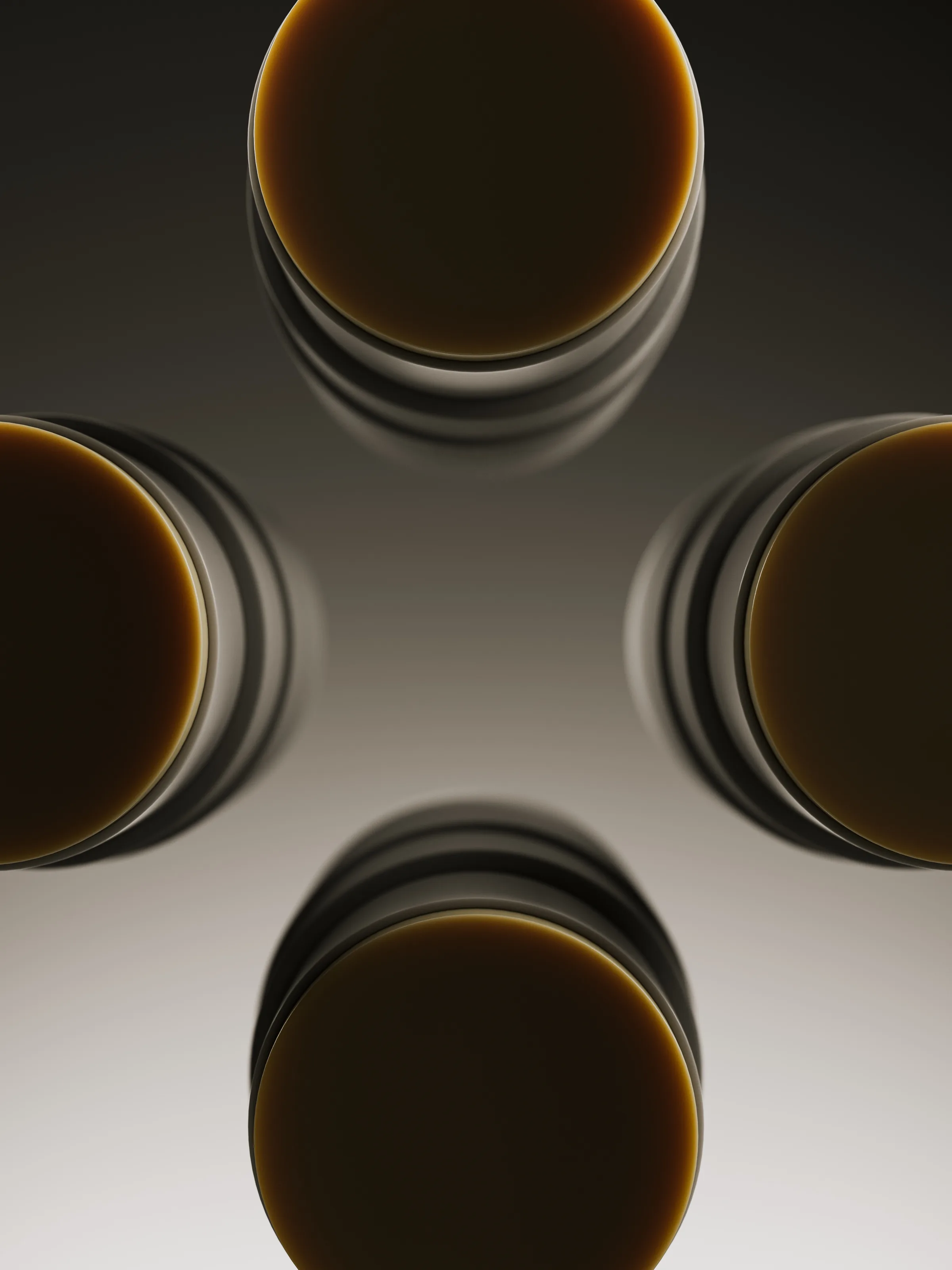 CGI render of four amber balm sticks seen from above, arranged in a cross on a dark-to-light gradient, for Talgh.