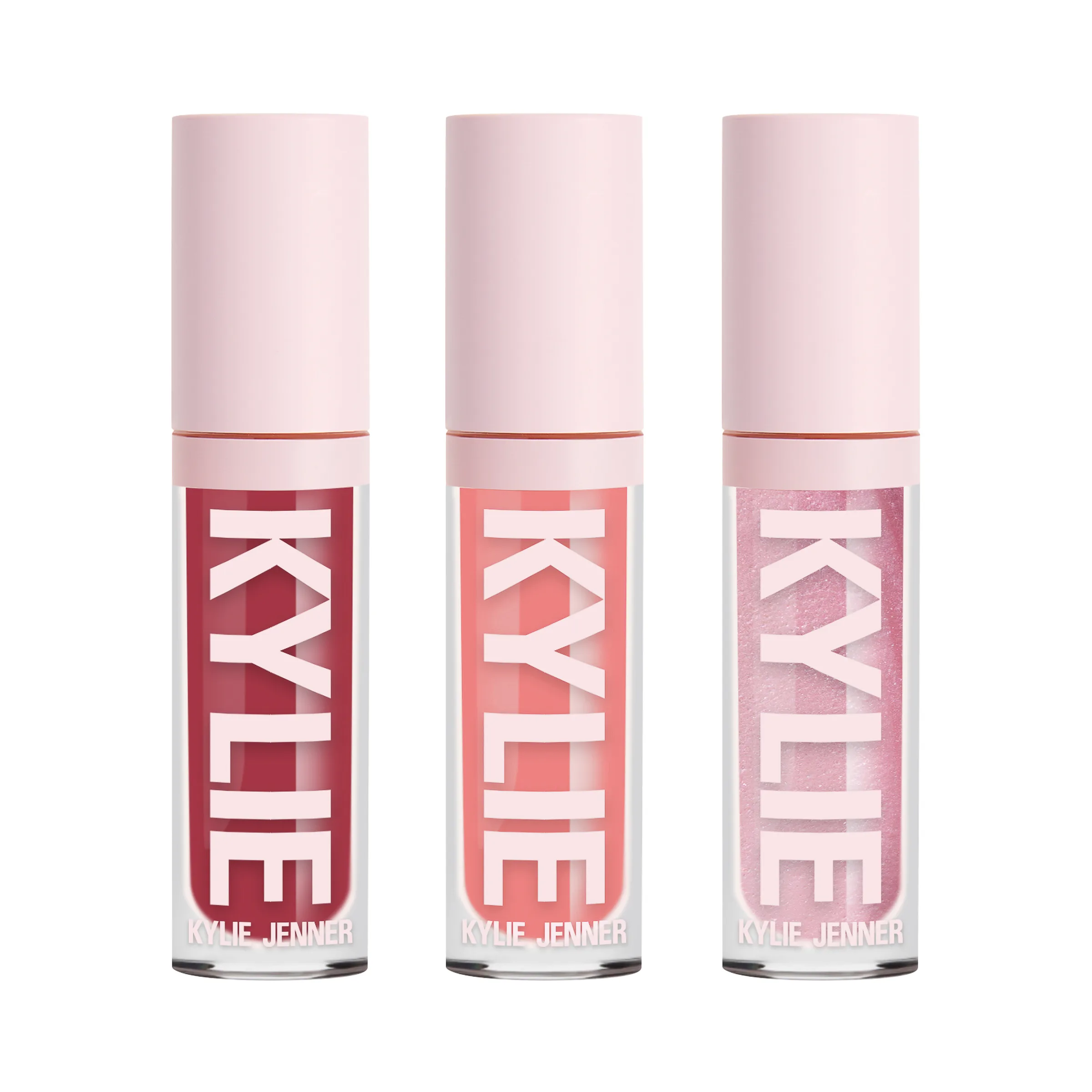 Three lip gloss tubes in berry, coral and shimmer pink with pale pink caps on a white background, for Kylie Cosmetics.