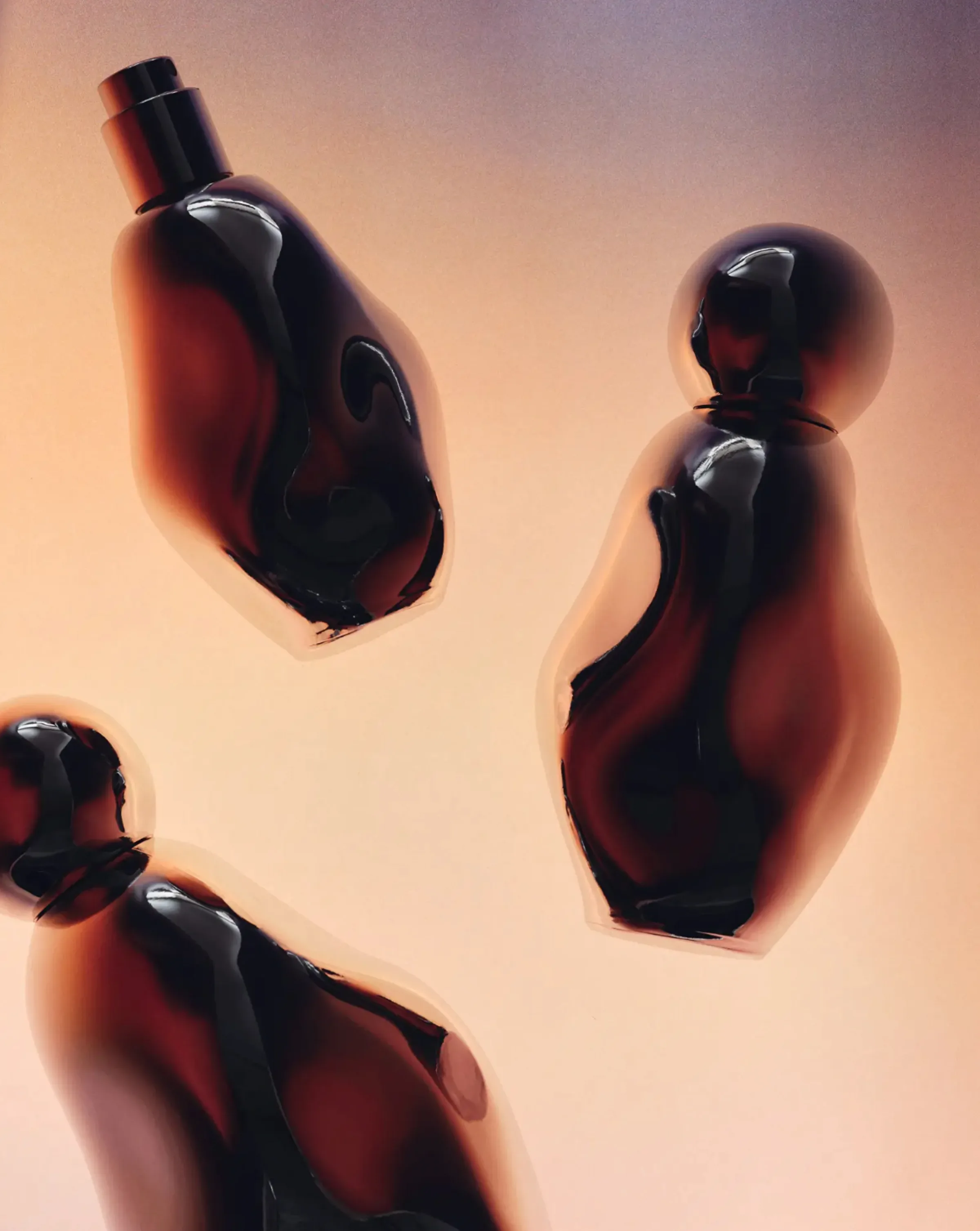 Three amber glass perfume bottles with organic curved shapes floating against a peach gradient backdrop, for Kylie Cosmetics.