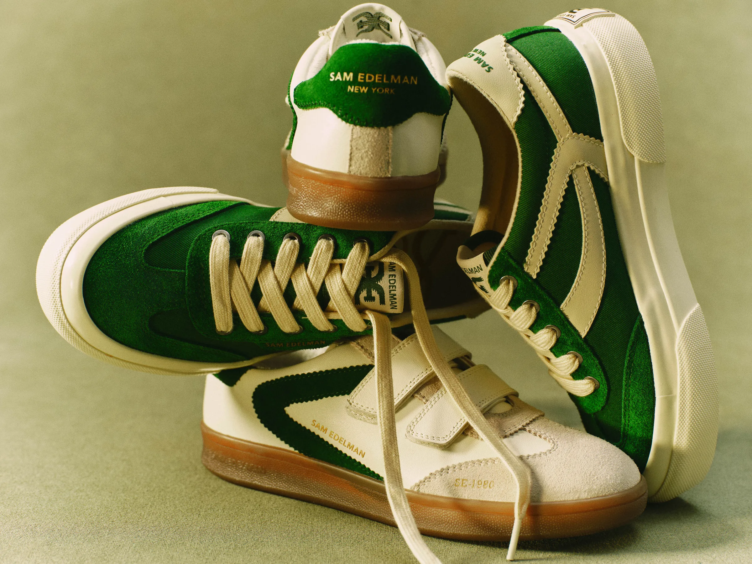Stacked green and cream suede sneakers with gum soles and laces on a sage green backdrop, for Sam Edelman.