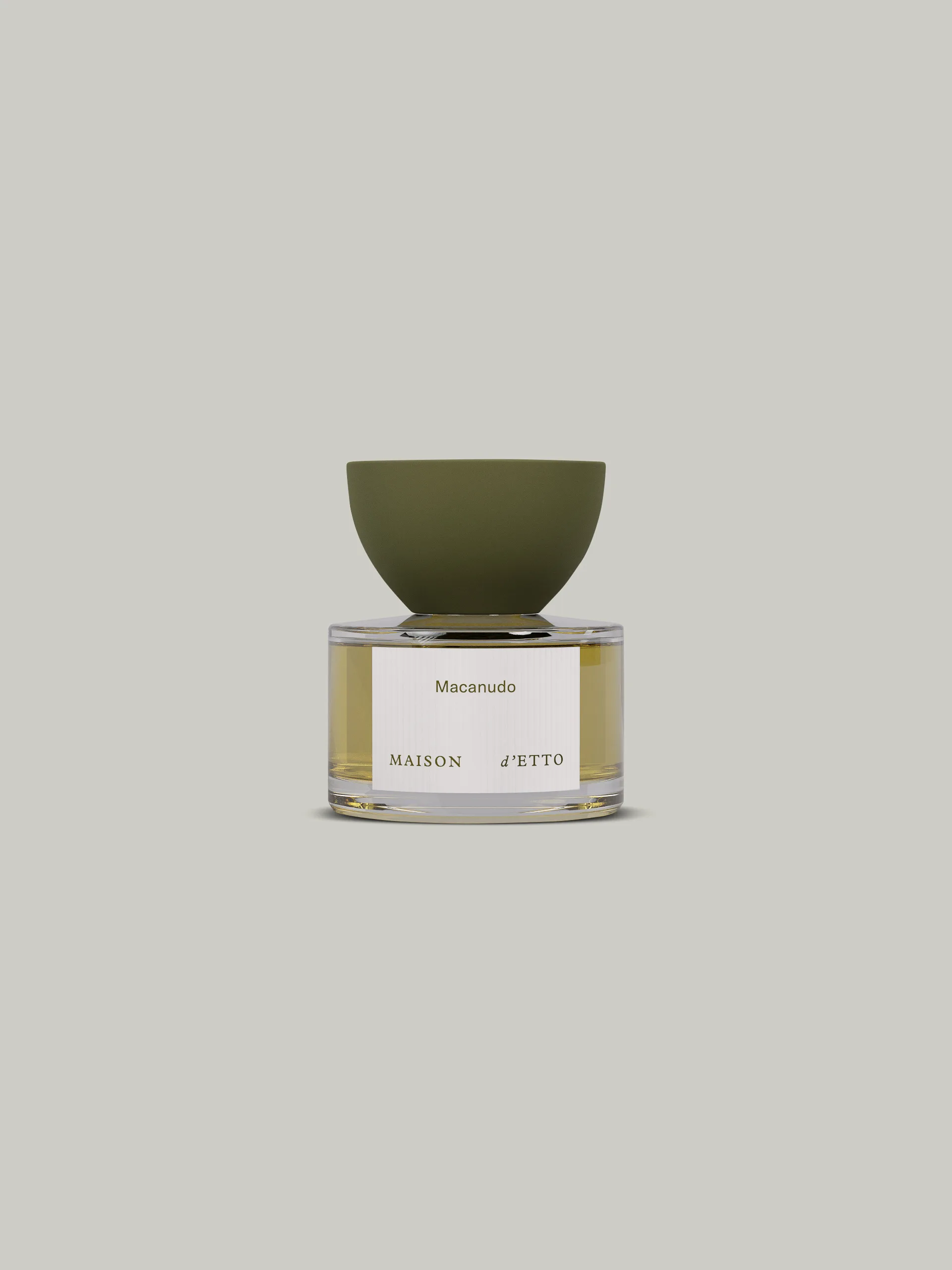 CGI render of a Macanudo perfume bottle with a green bowl-shaped cap on a pale grey background, for Maison d'Etto.