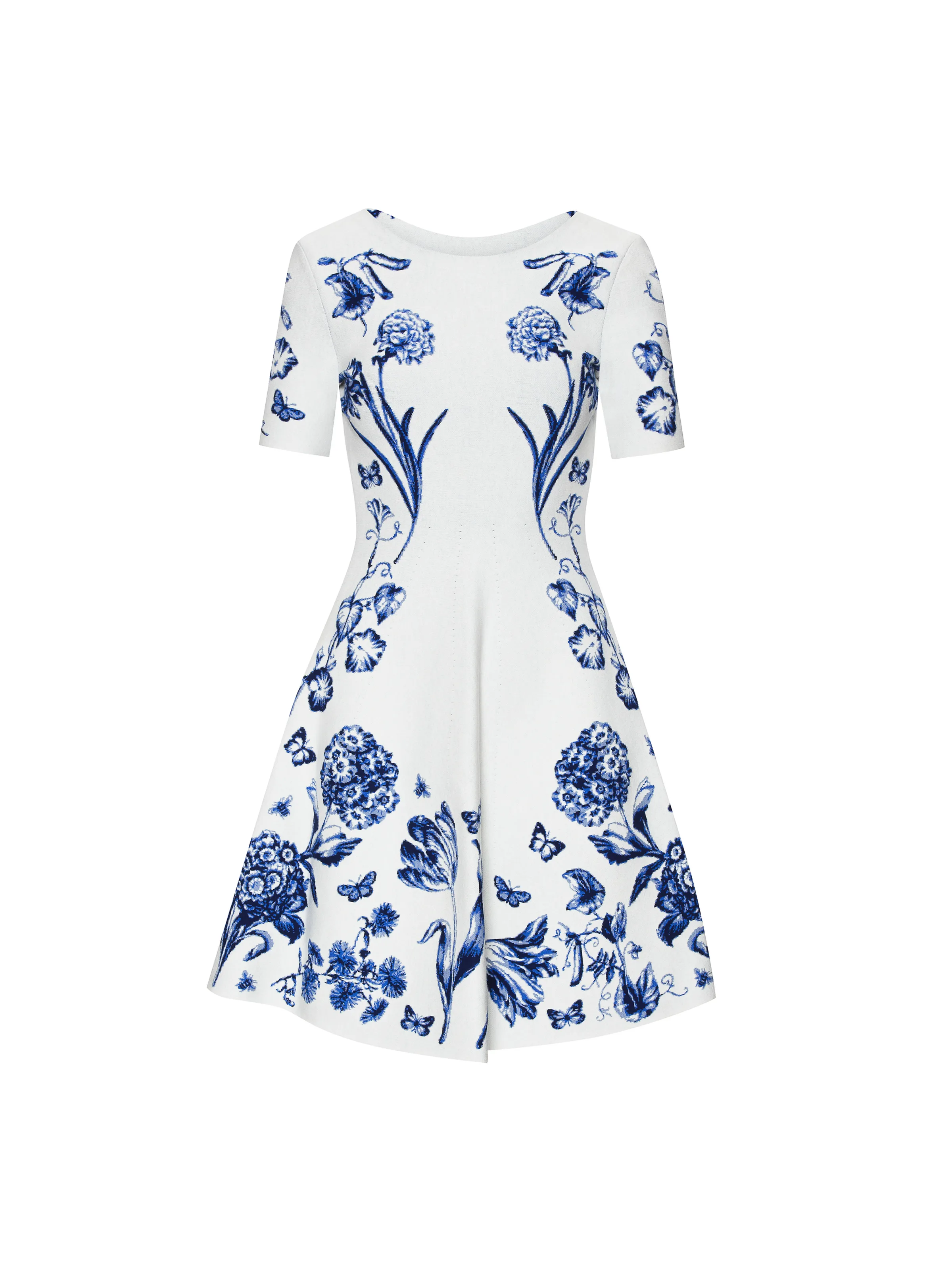 White short-sleeve knit dress with blue botanical and butterfly print, shown on a plain white background, for Oscar de la Renta.