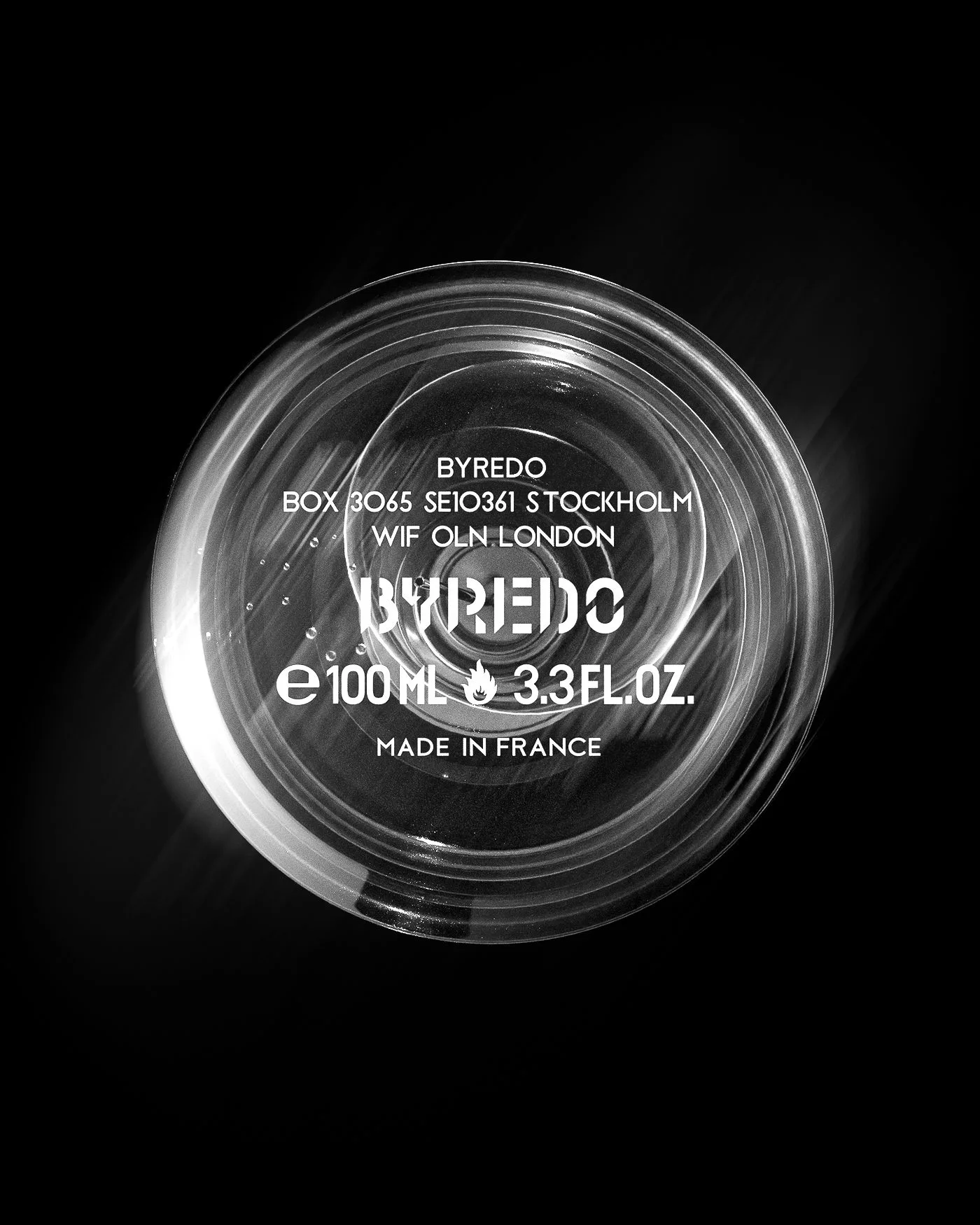 CGI render of a clear perfume bottle base seen from below, printed with white text and 100 ml on black, for Byredo.