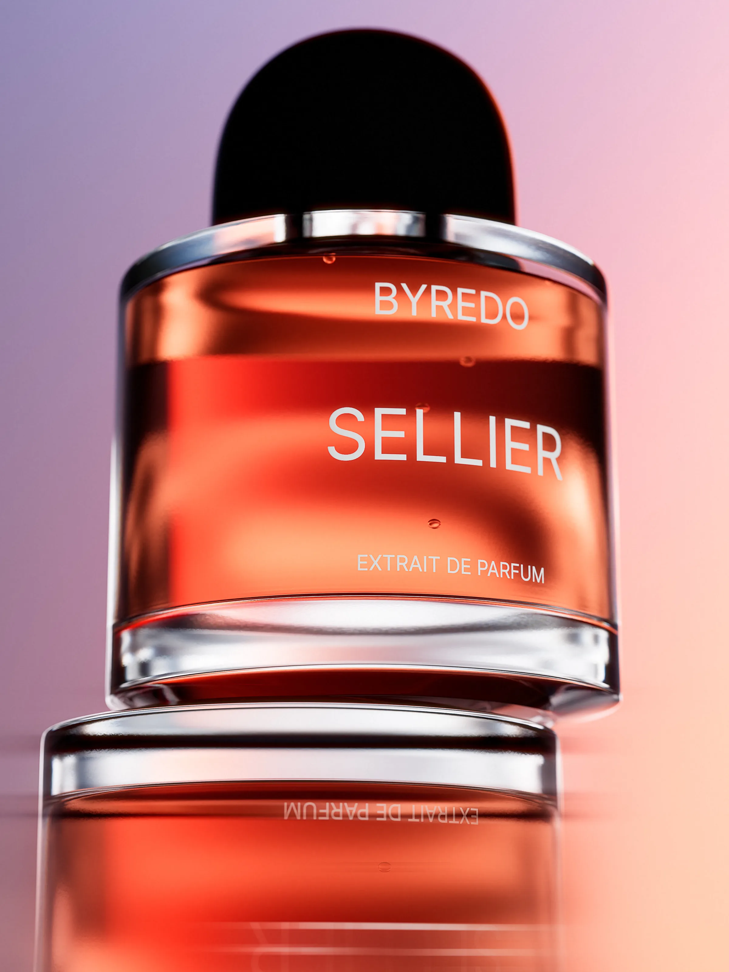 CGI render of a Sellier extrait de parfum bottle with amber liquid, reflected on a glossy surface against a pink gradient, for Byredo.
