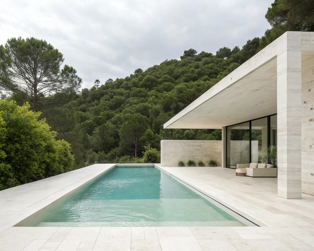 AI image of a pale travertine villa with a turquoise lap pool and covered terrace beside a forested hillside. AI Concept.