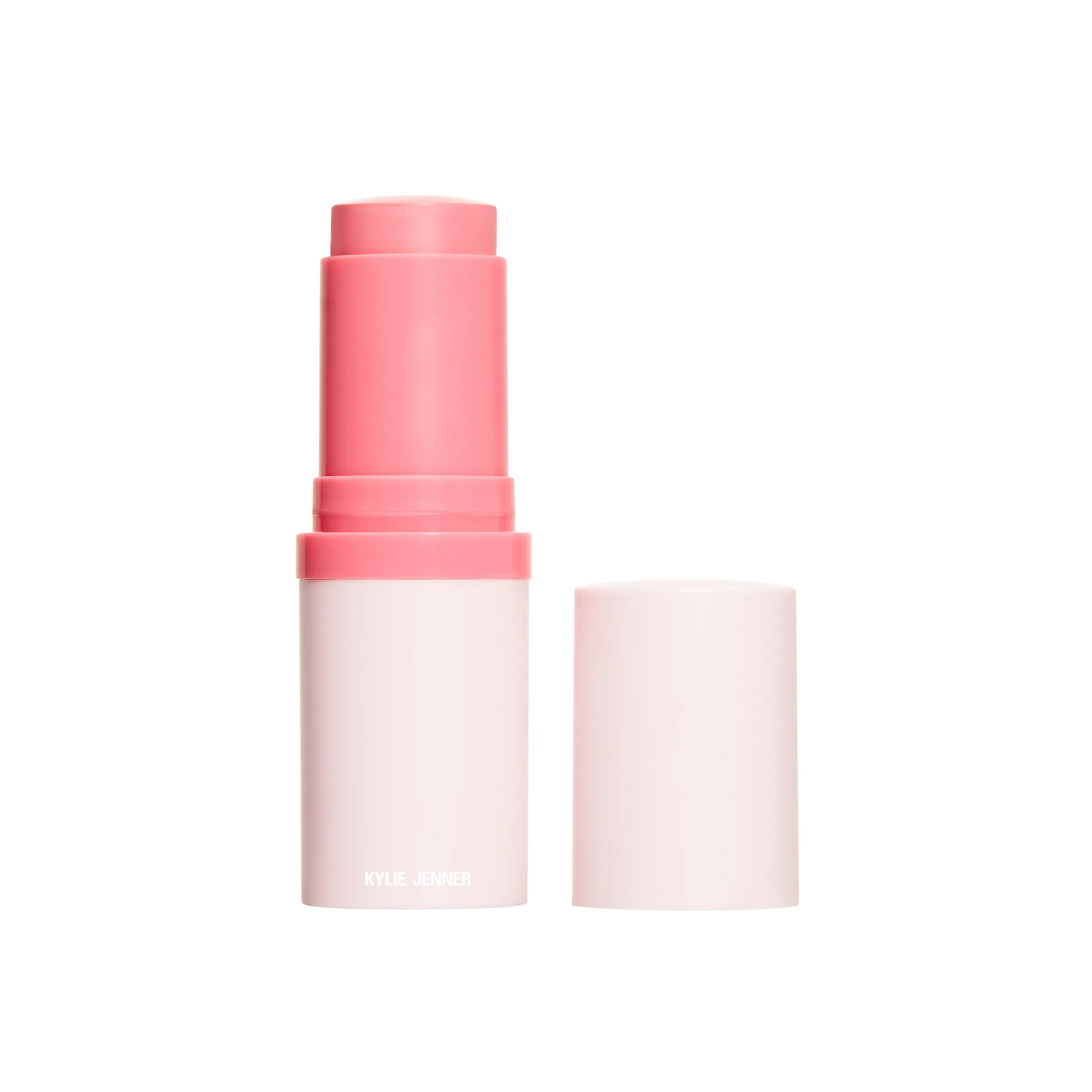 Pink blush stick uncapped beside its pale pink cap on a white background, for Kylie Cosmetics.