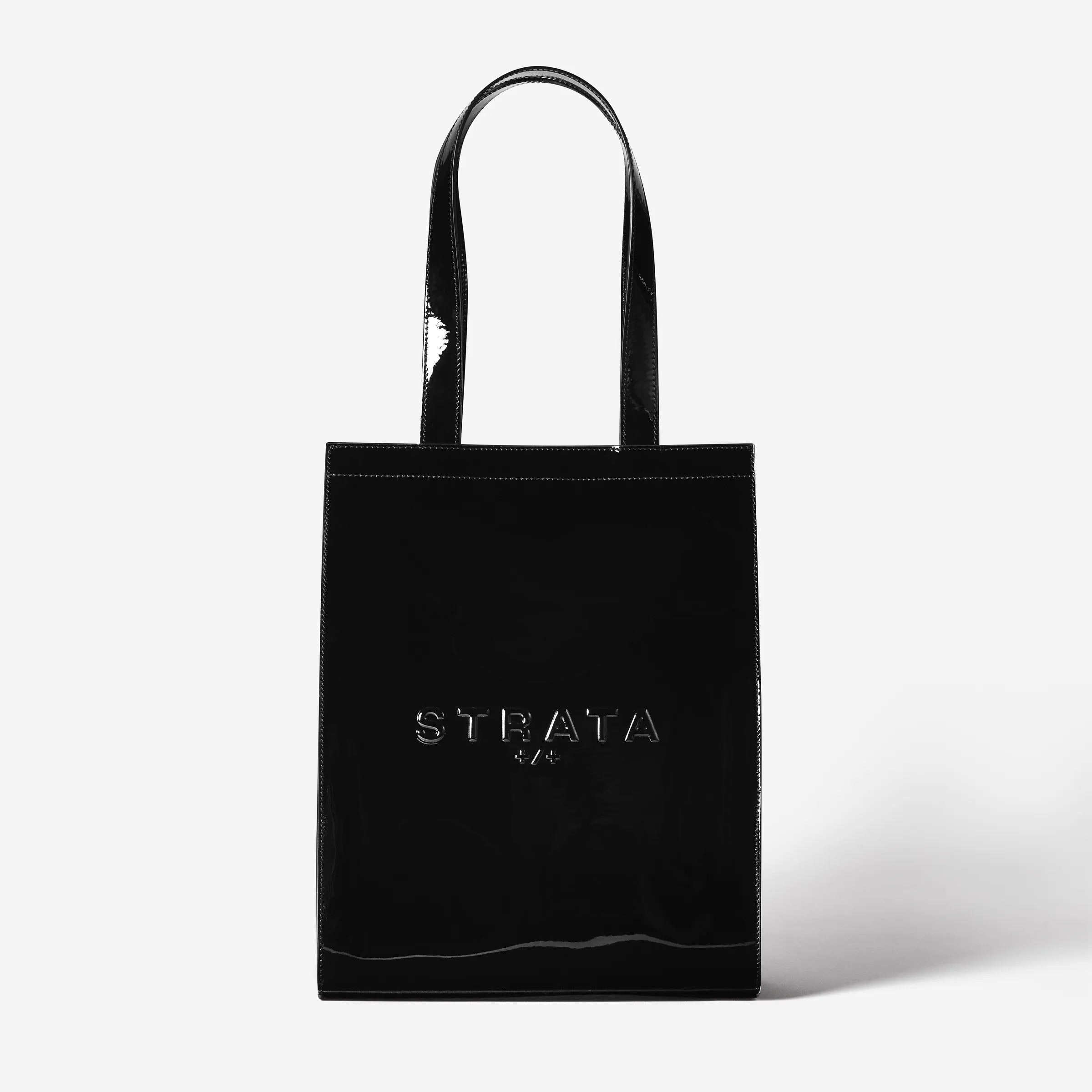 Black patent leather Carmen tote bag with embossed logo, shot front-on against a white background, for Strata.