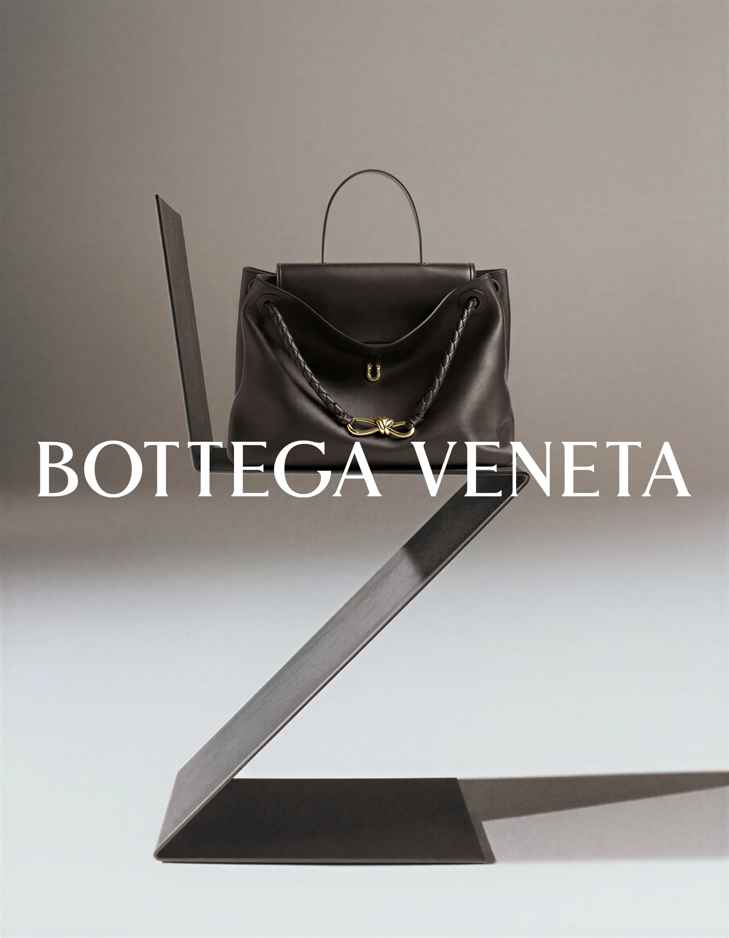 AI image of a dark brown leather handbag with gold knot hardware on a black zigzag chair. Bottega Veneta AI Concept.