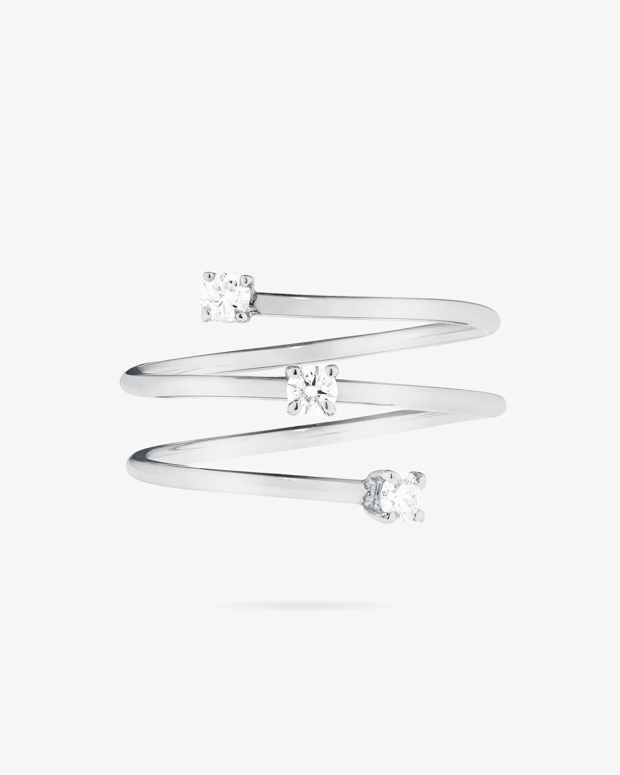White gold coil wrap ring set with three round diamonds on a plain white background, for LANA Jewelry.