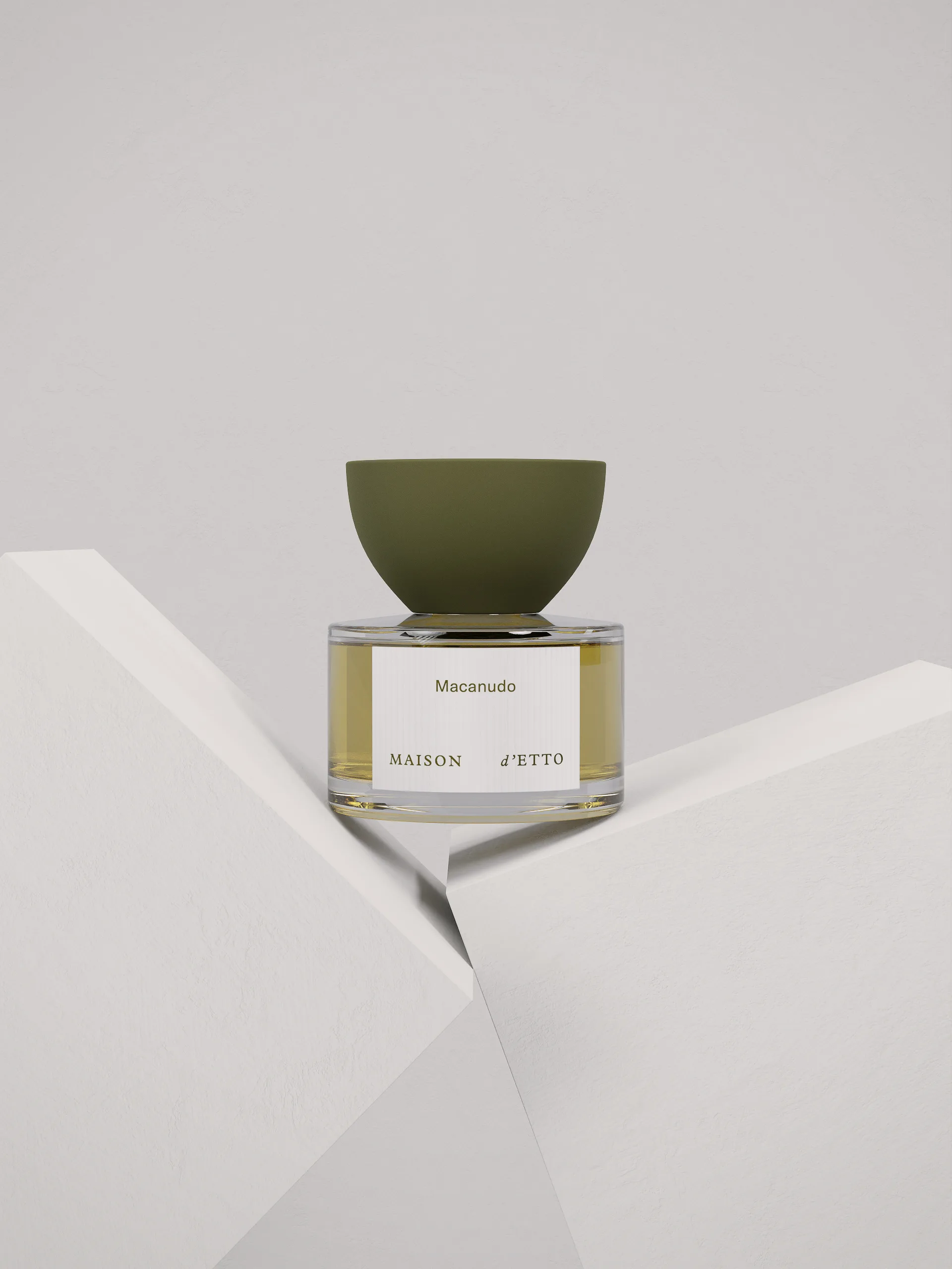 CGI render of a Macanudo perfume bottle with olive green cap balanced between white blocks, for Maison d'Etto.