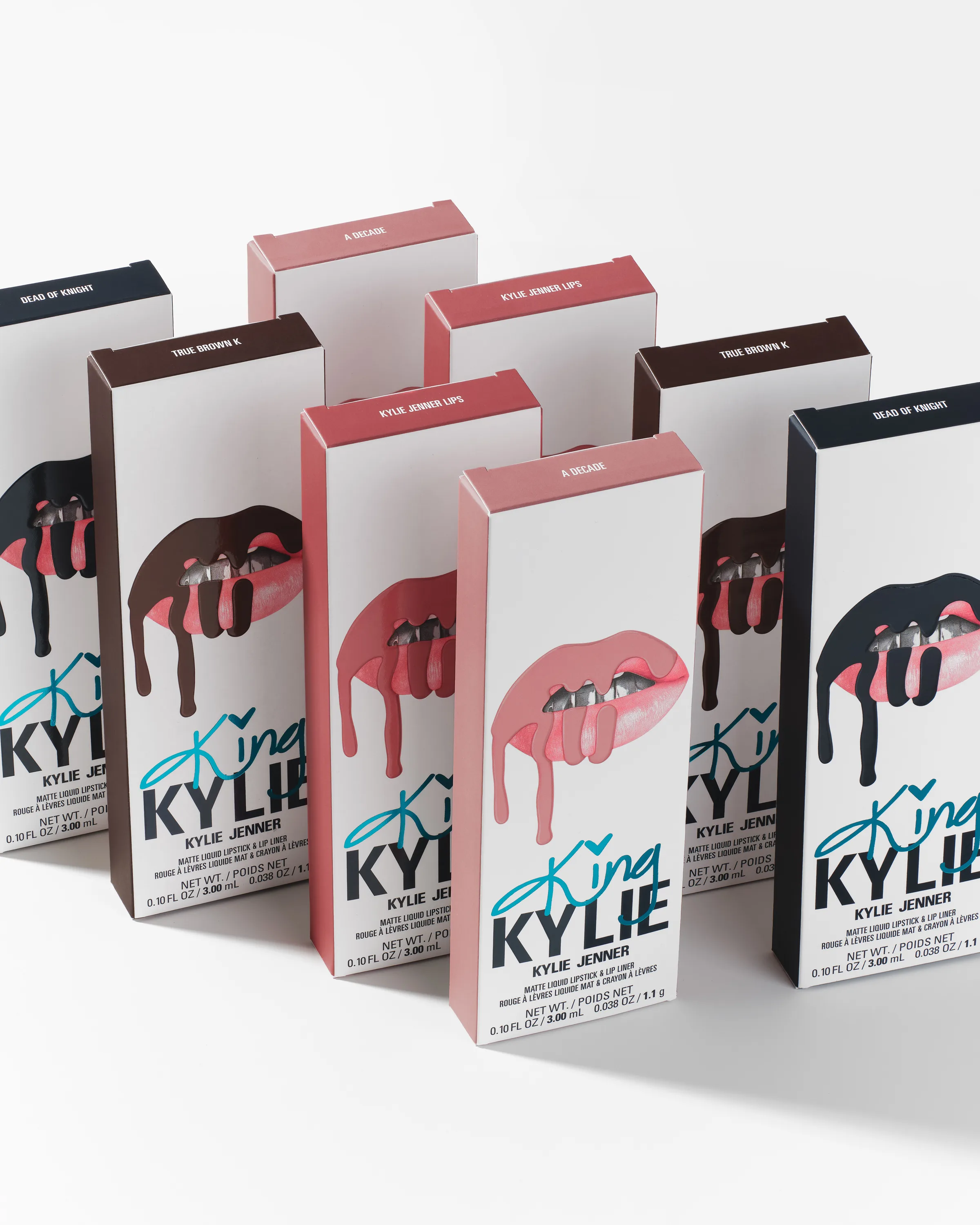 Rows of King Kylie lip kit boxes with dripping lip artwork in nude, pink, brown and navy shades, for Kylie Cosmetics.