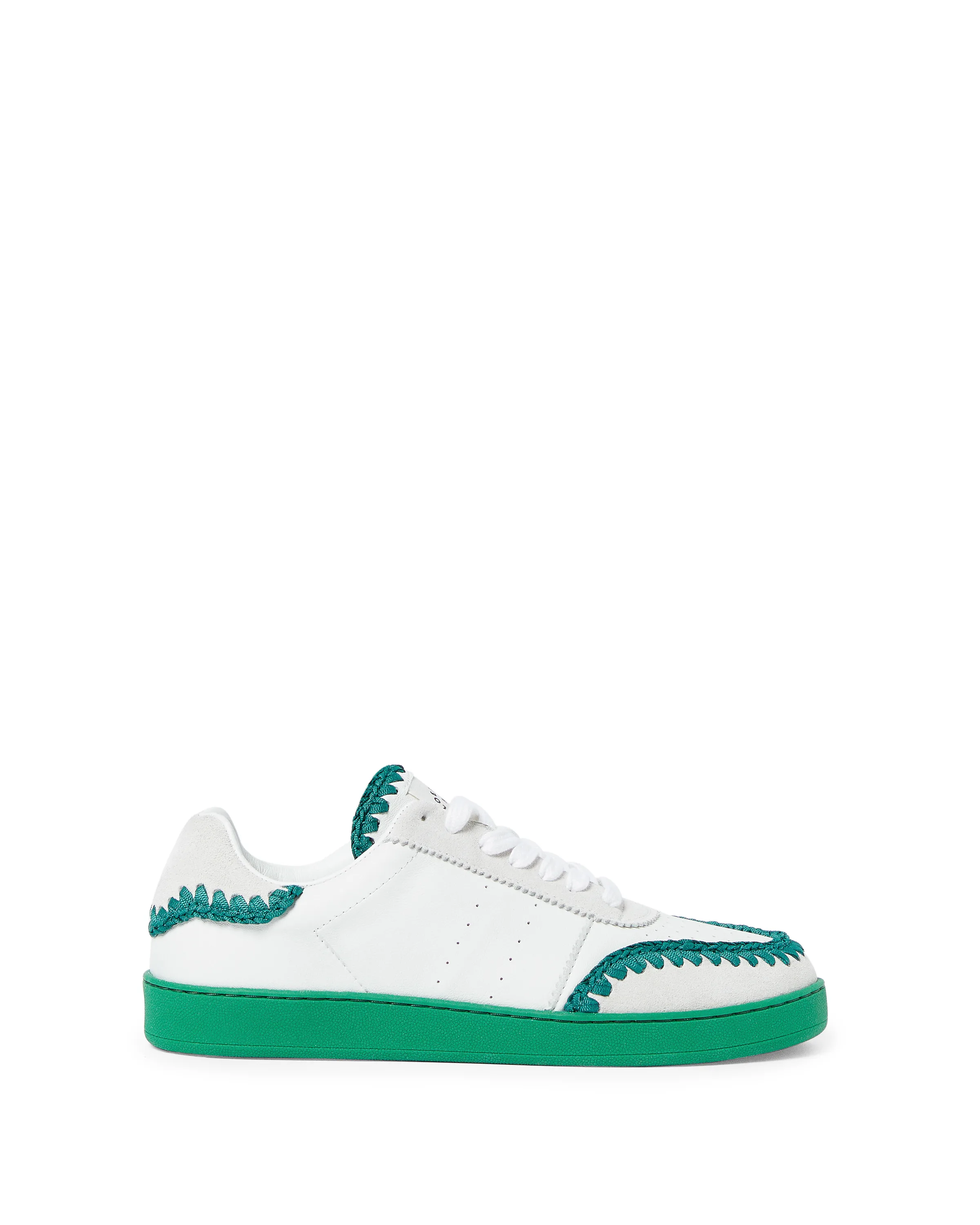 White leather and suede low-top sneaker with green crochet trim and green sole on white background, for Loeffler Randall.