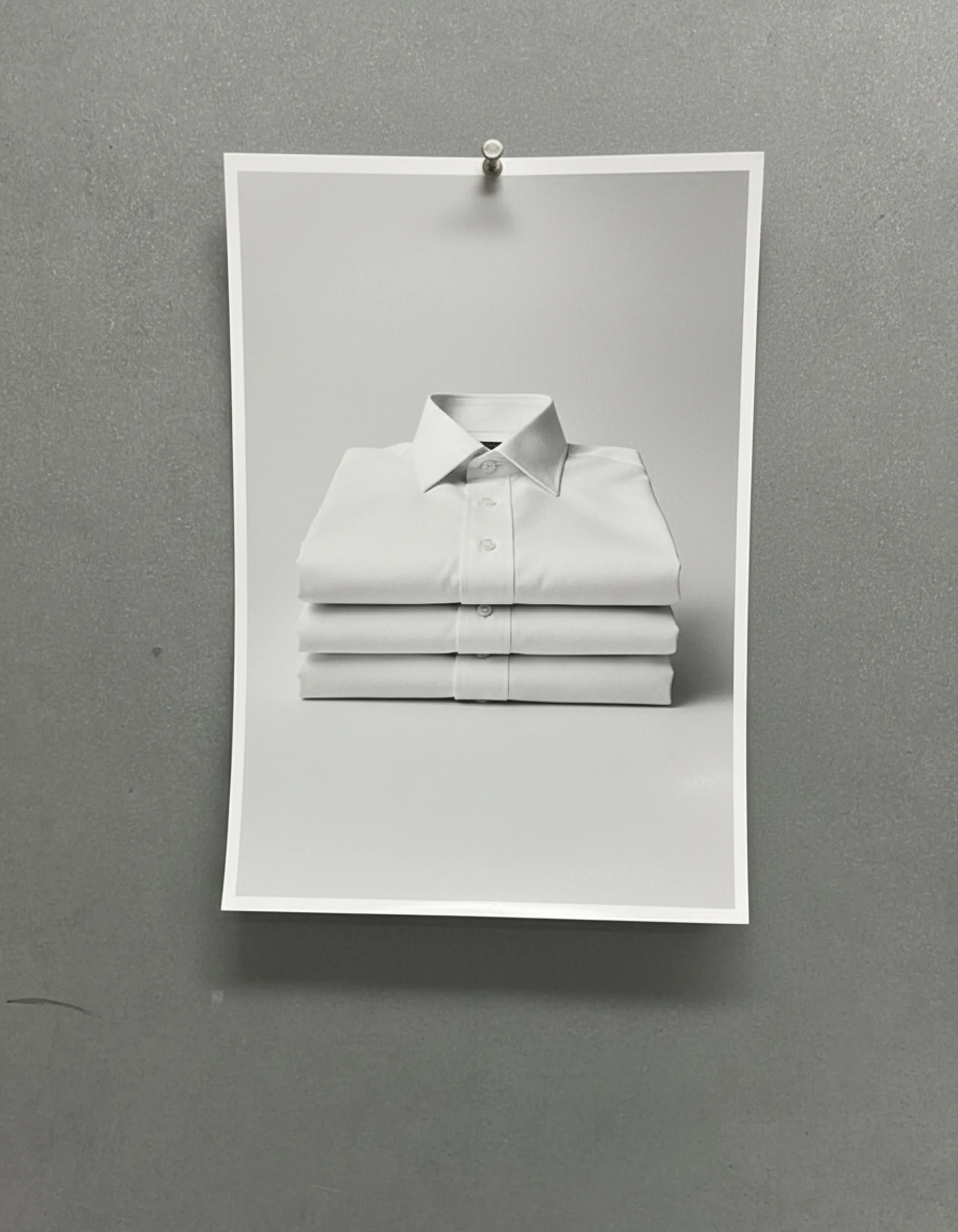 AI image of a print showing three folded white dress shirts, pinned to a grey wall. Suitsupply AI Concept.