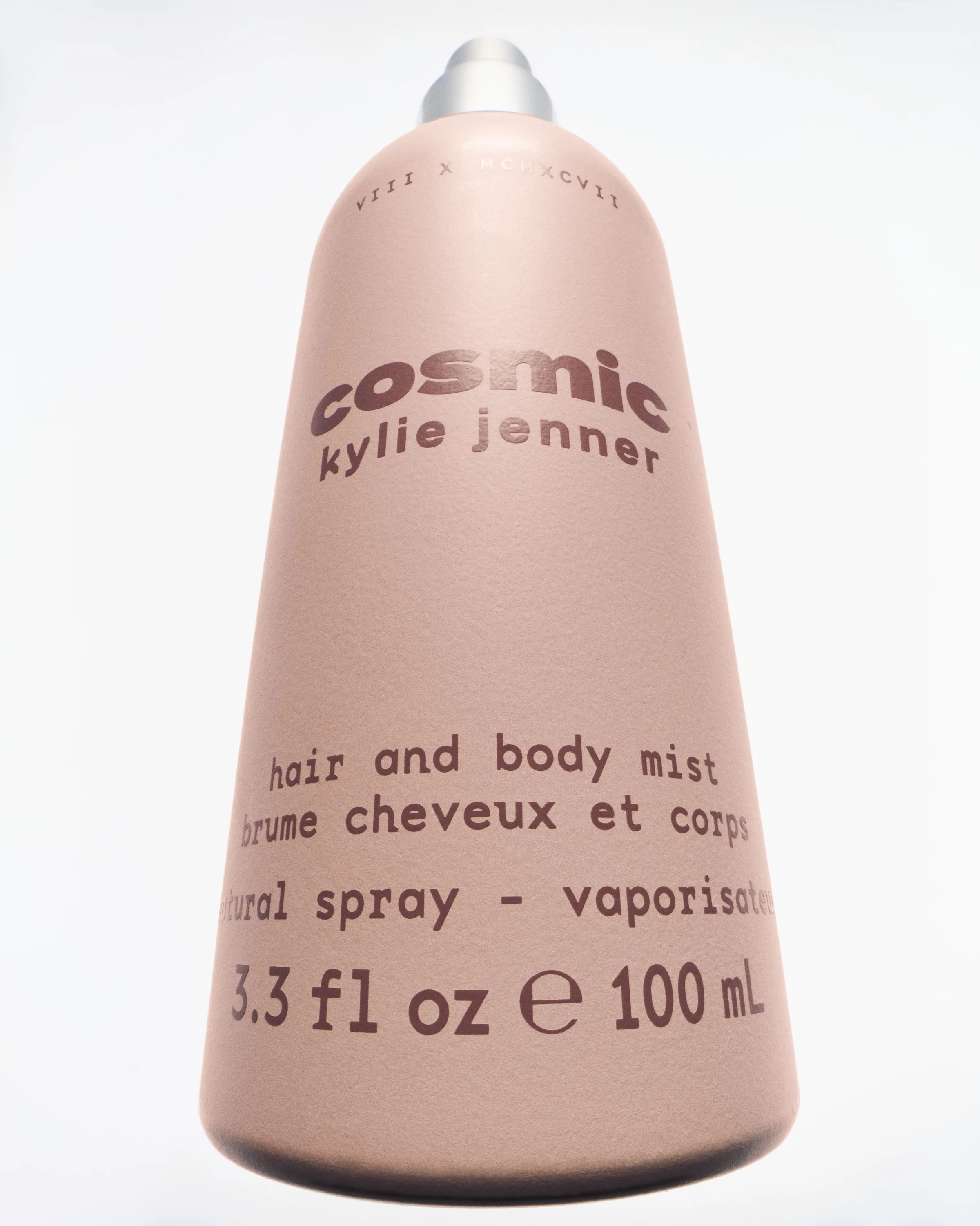 Pink Cosmic Kylie Jenner hair and body mist bottle shot from below against a white background, for Kylie Cosmetics.