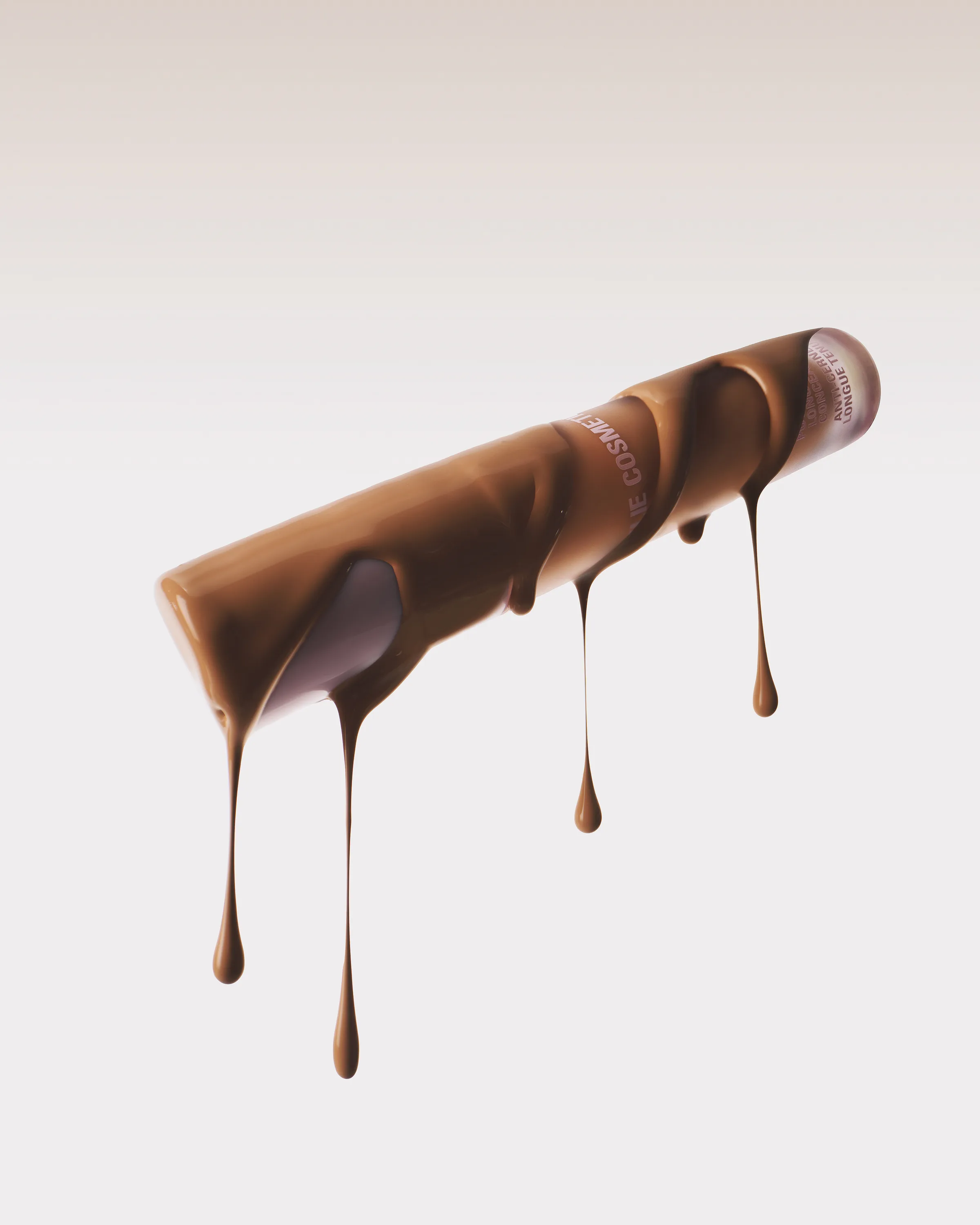 Floating cosmetic tube coated in tan liquid foundation dripping downward on a pale backdrop, for Kylie Cosmetics.