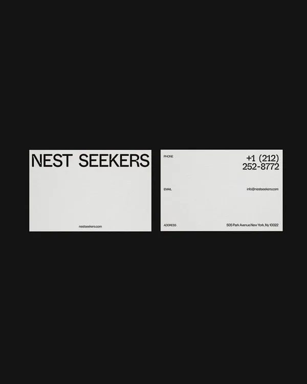White business cards on black, front with black wordmark and back with phone, email and Park Avenue address, for Nest Seekers.