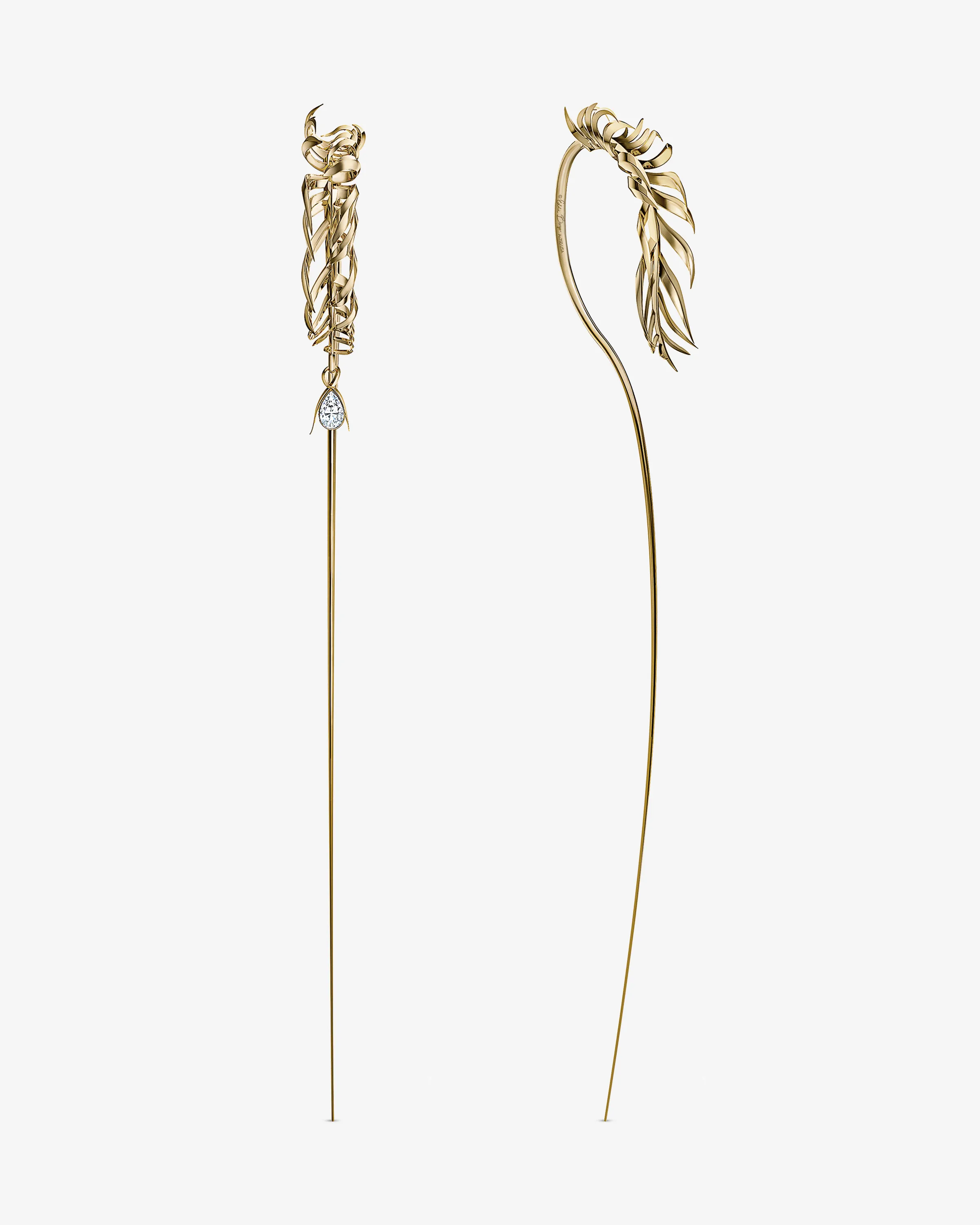 CGI render of two long gold hair pins with feathered tops, one set with a pear-cut diamond, for Eddie Borgo.