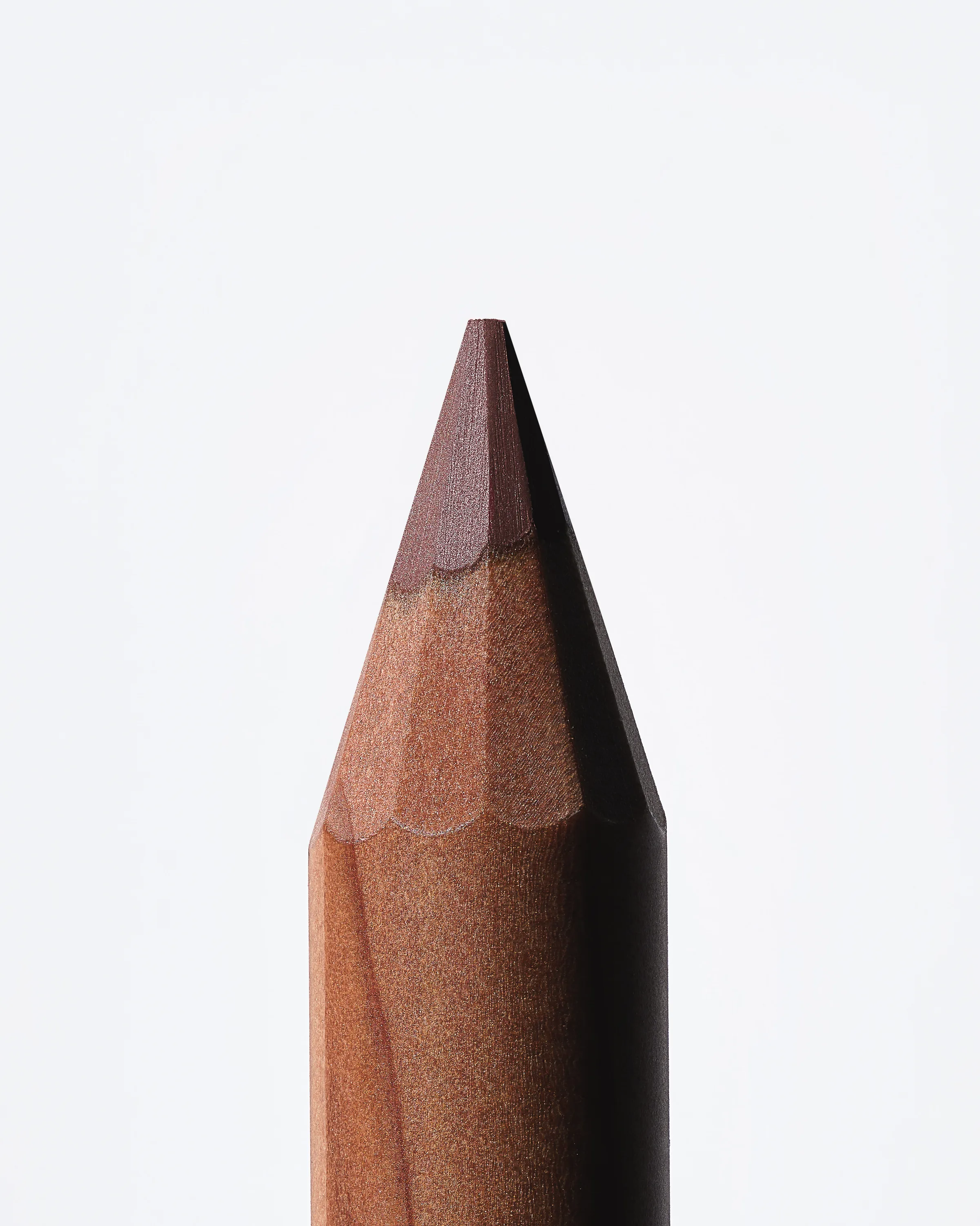 Close-up of a sharpened wooden lip liner pencil with a mauve tip on a white background, for Kylie Cosmetics.