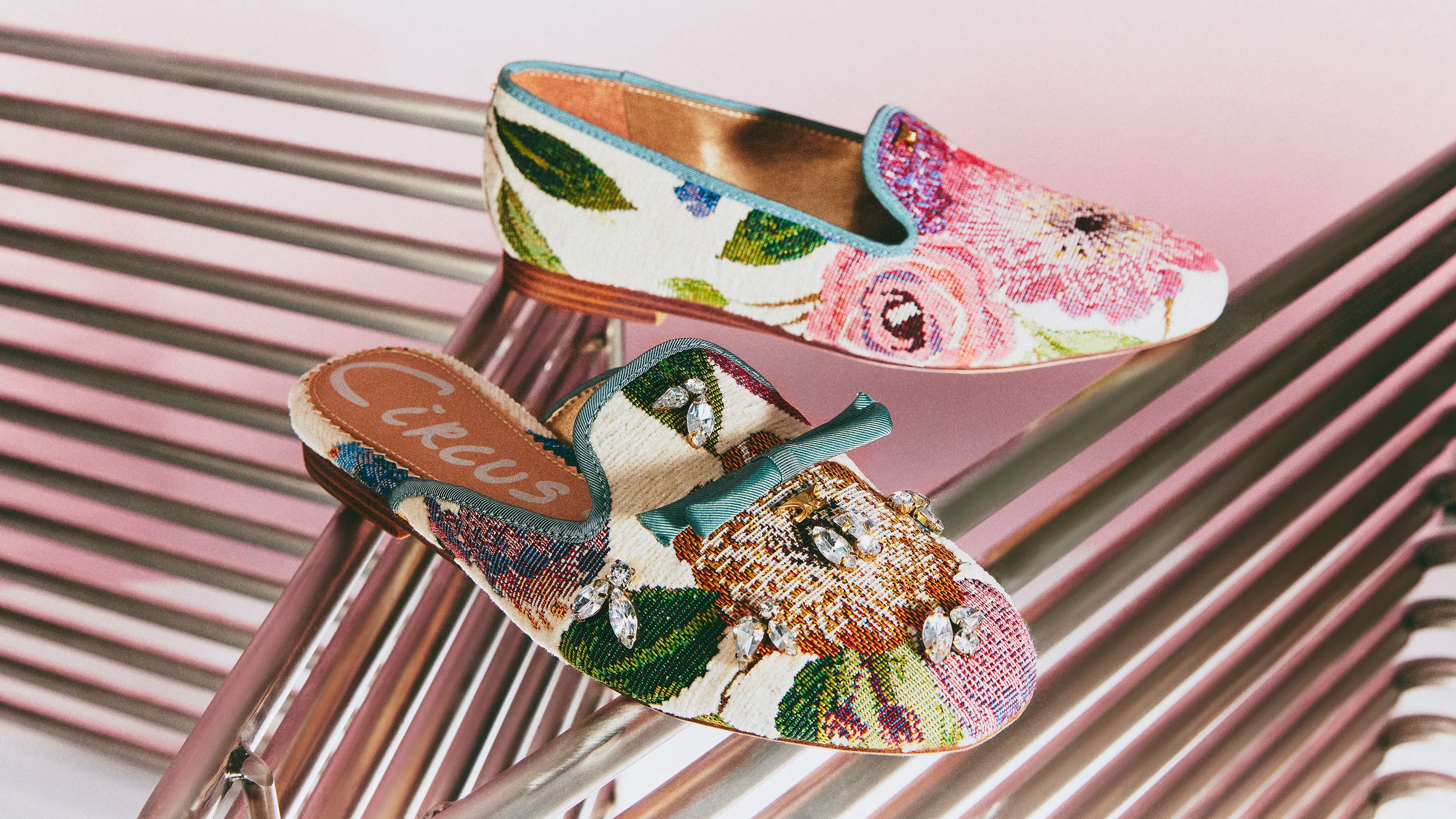 Floral tapestry loafer and jewelled bow mule on a metal chair against a pink backdrop, for Circus NY.