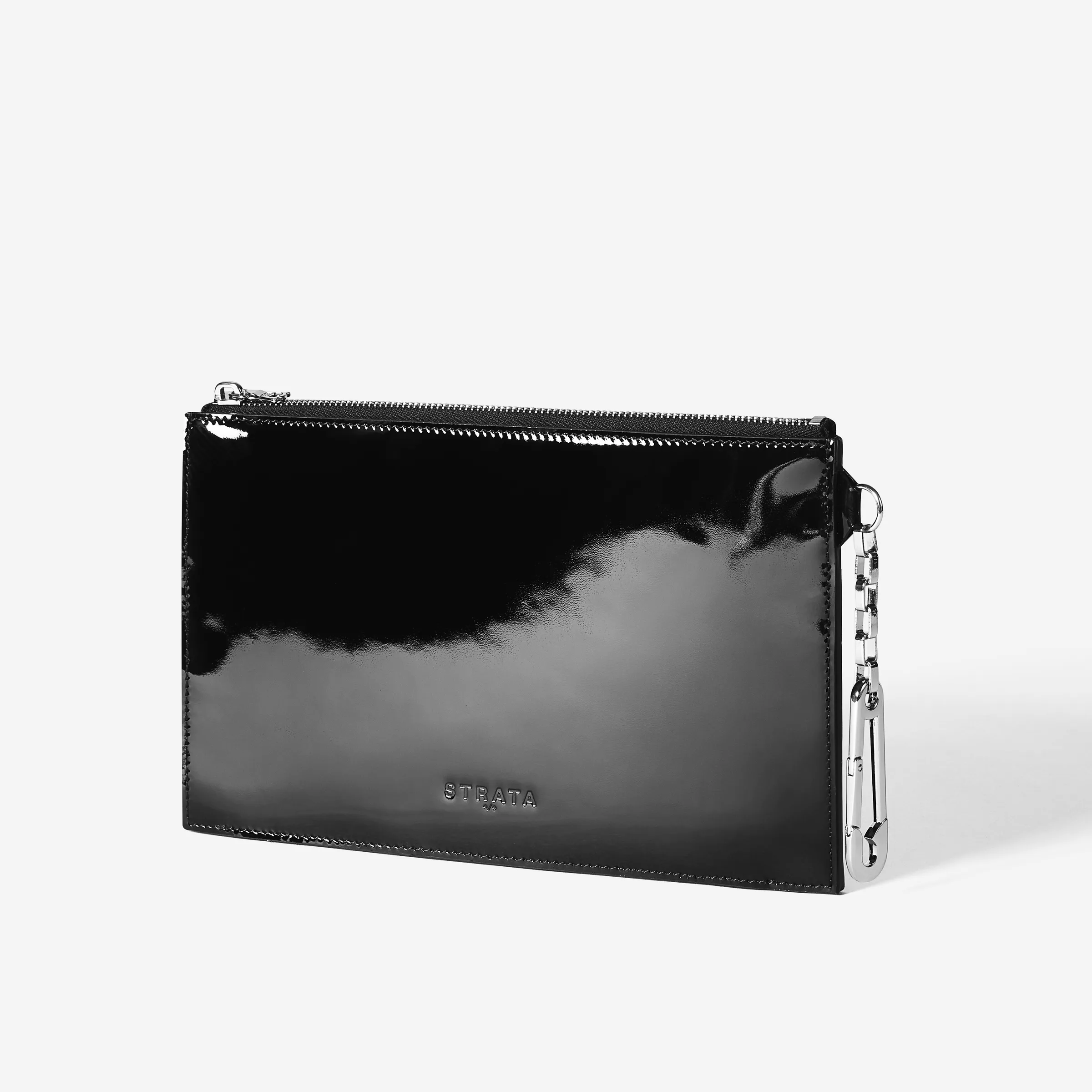 Black patent leather flat zip clutch with silver chain clip, three-quarter view on a white background, for Strata.
