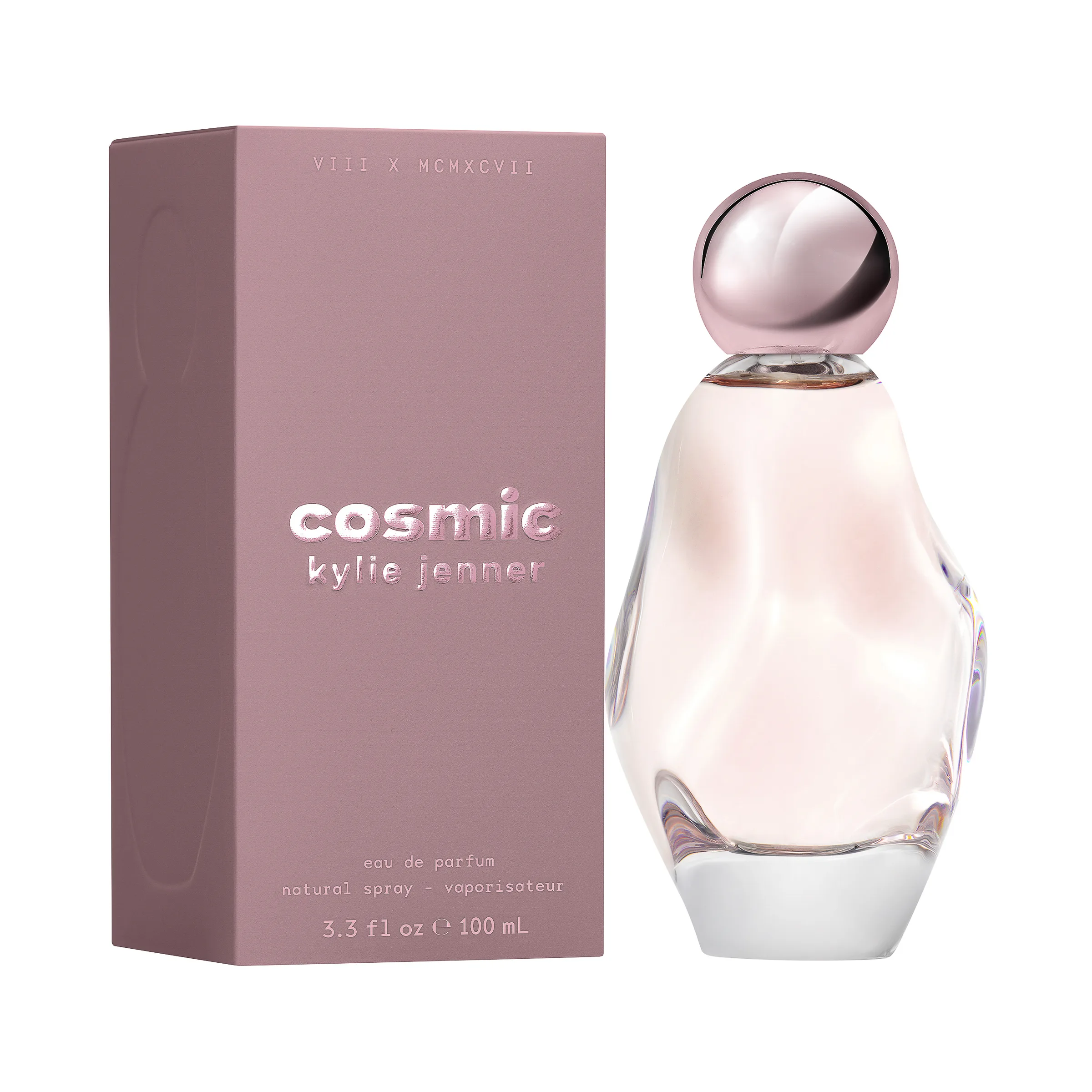 Cosmic eau de parfum bottle with pink glass and orb cap beside its mauve box on white, for Kylie Cosmetics.