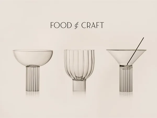 Three clear fluted glasses, a coupe, tumbler and martini glass, on a beige backdrop under the wordmark, for Food & Craft.
