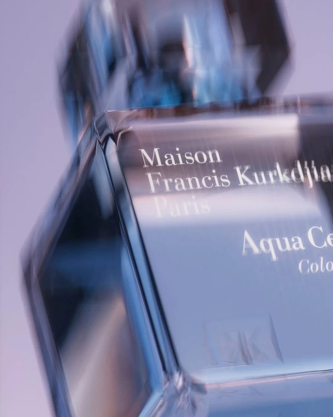 CGI render of an Aqua Celestia cologne glass bottle in close-up with motion blur on lilac, for Maison Francis Kurkdjian.