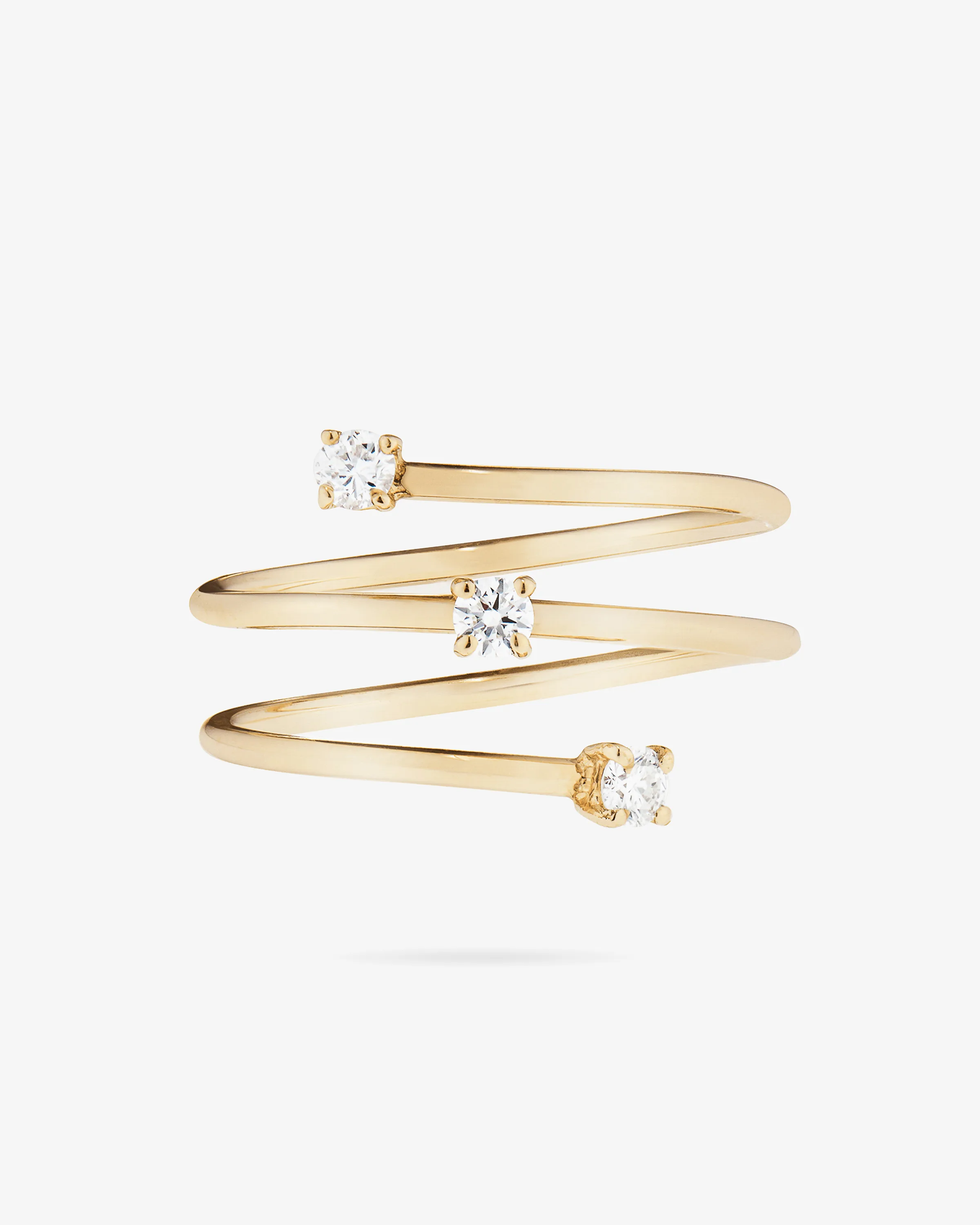 Gold spiral wrap ring set with three round diamonds on a white background, for LANA Jewelry.