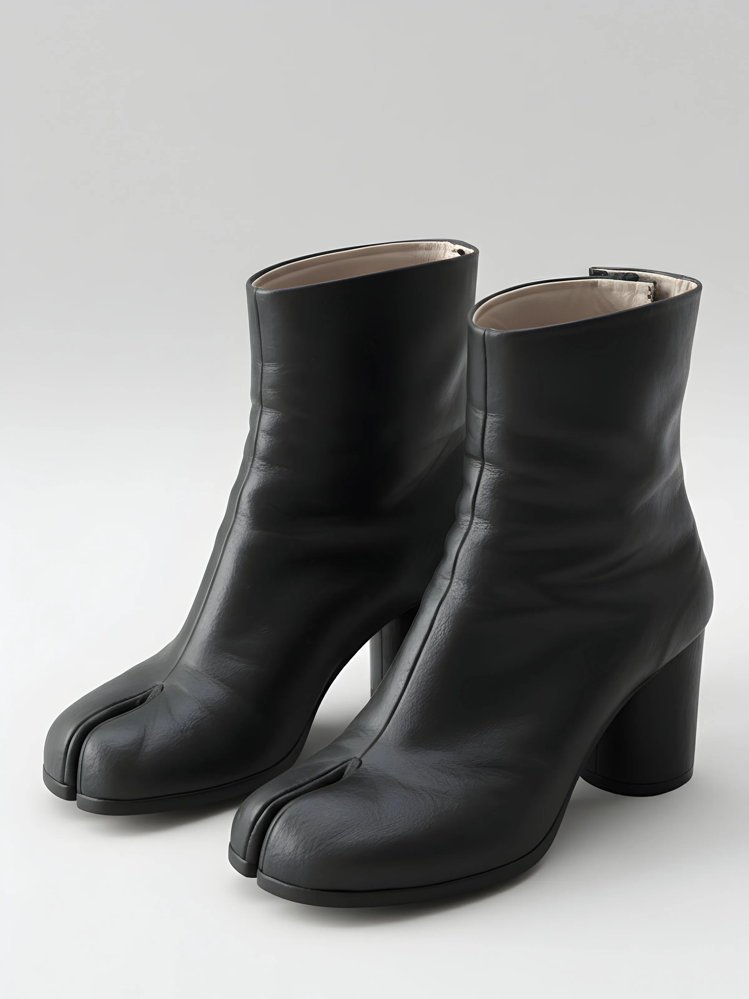 AI image of black leather split-toe Tabi ankle boots with block heels on a pale grey background. Maison Margiela AI Concept.