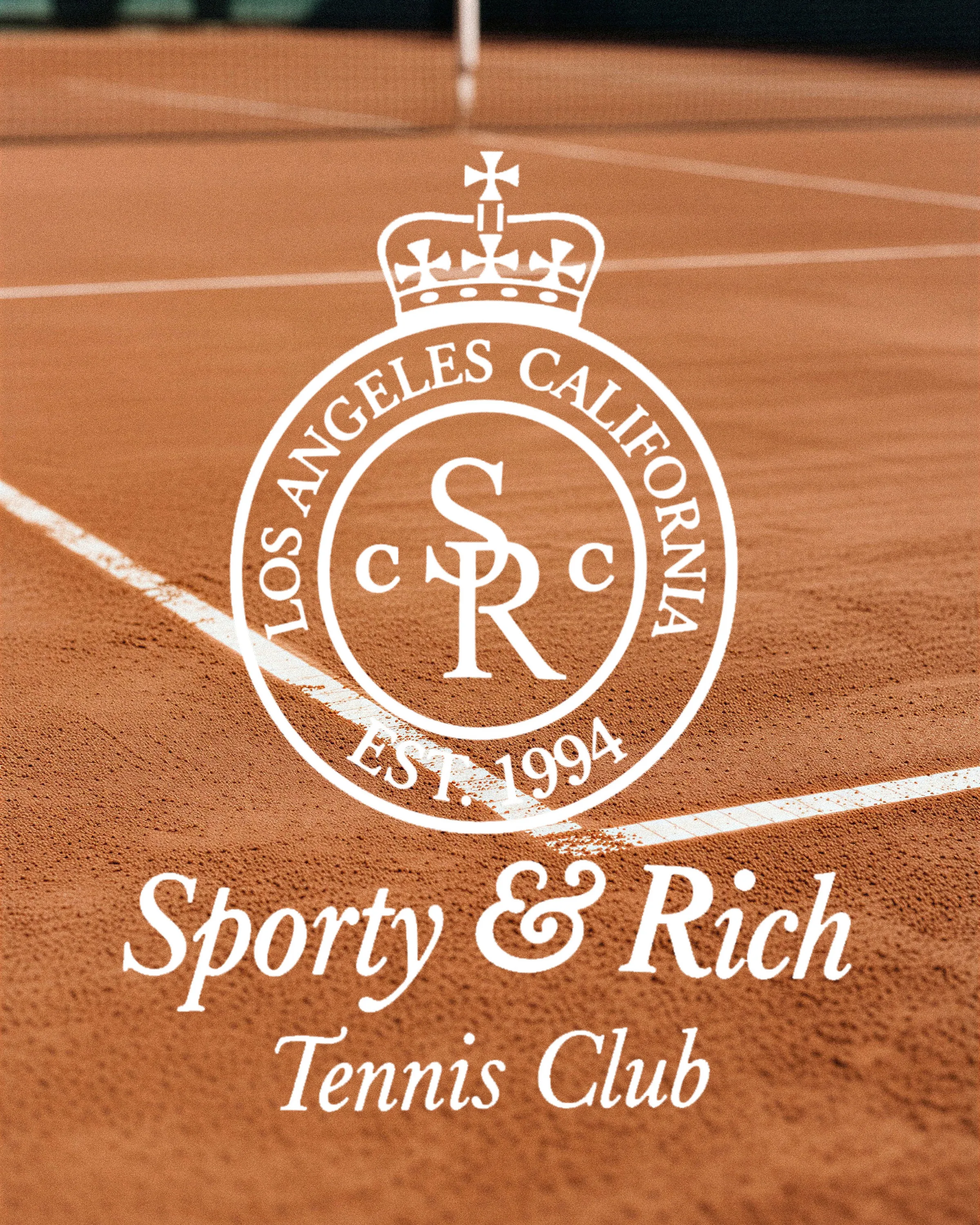 AI image of a white Tennis Club crest and script logo over a blurred clay tennis court. Sporty & Rich AI Concept.
