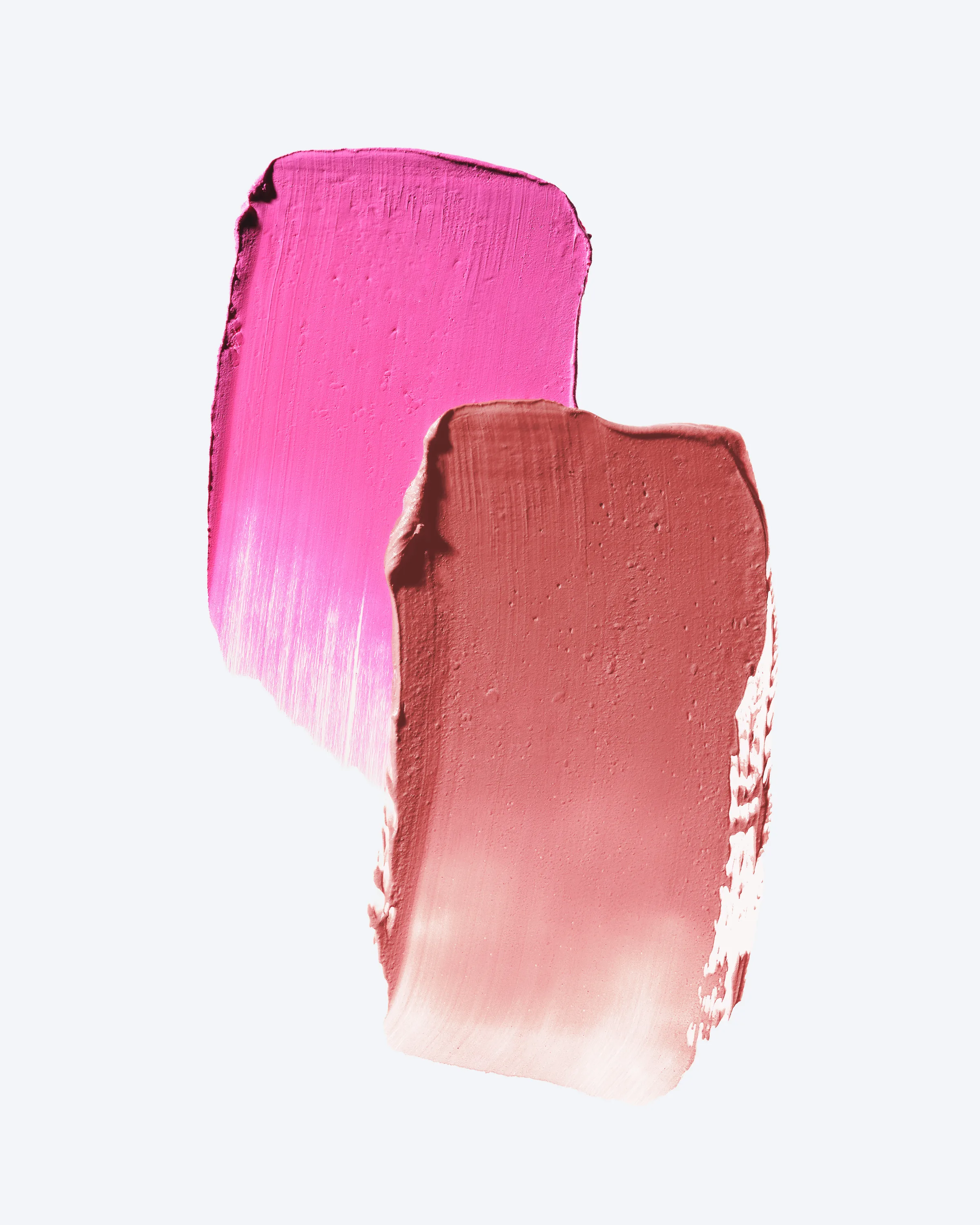 Glow balm swatches in hot pink and dusty rose smeared on a pale grey background, for Kylie Cosmetics.