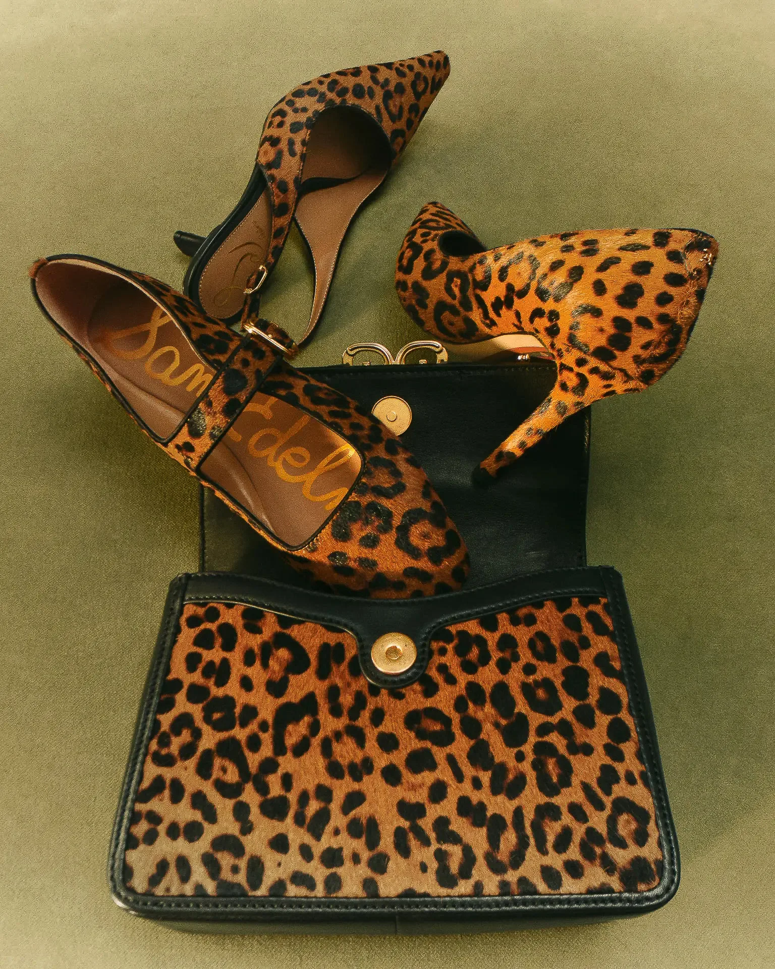 Leopard-print calf hair pumps, Mary Jane flat and black-trimmed handbag on green velvet, for Sam Edelman.