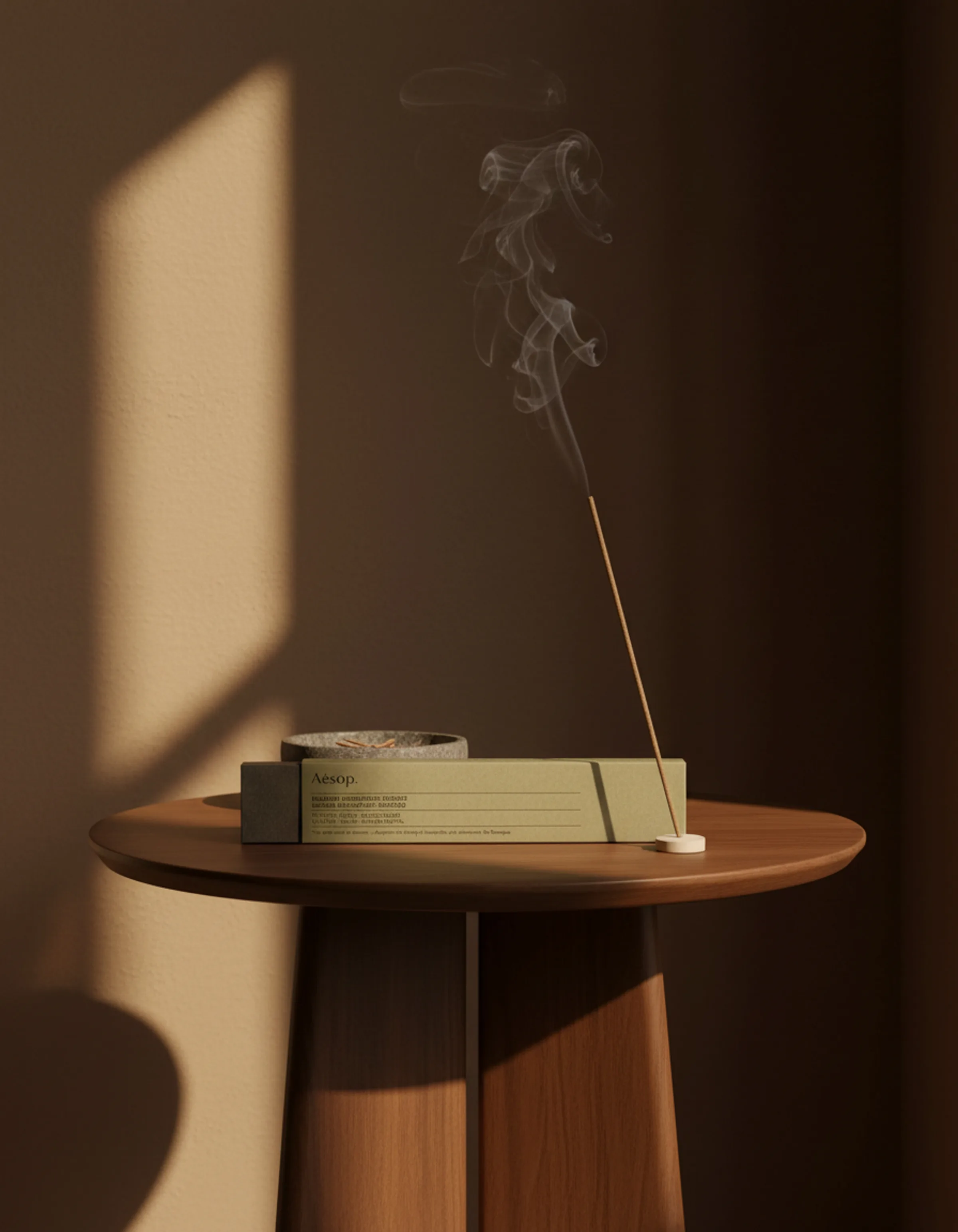 AI image of a burning incense stick beside an olive green box on a wooden side table in warm window light. Aesop AI Concept.