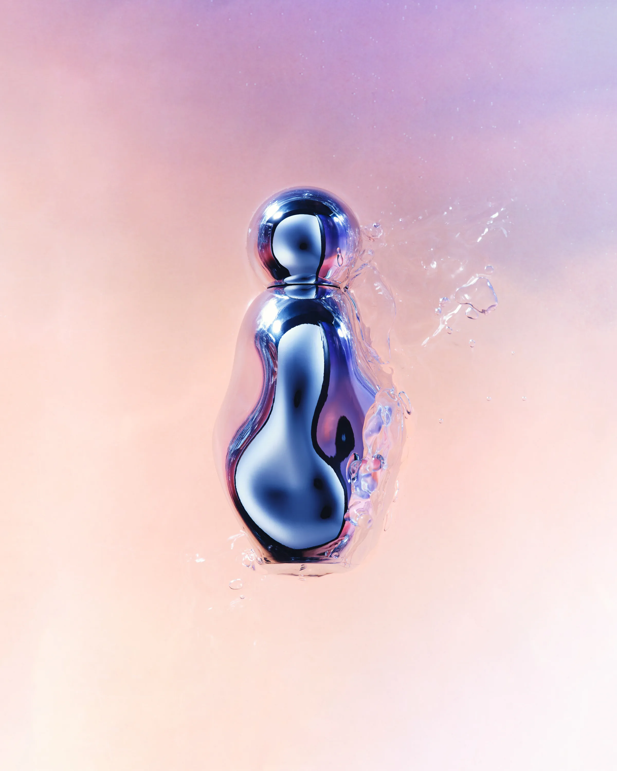 Chrome curved perfume bottle splashing through water against a soft pink and lilac backdrop, for Kylie Cosmetics.